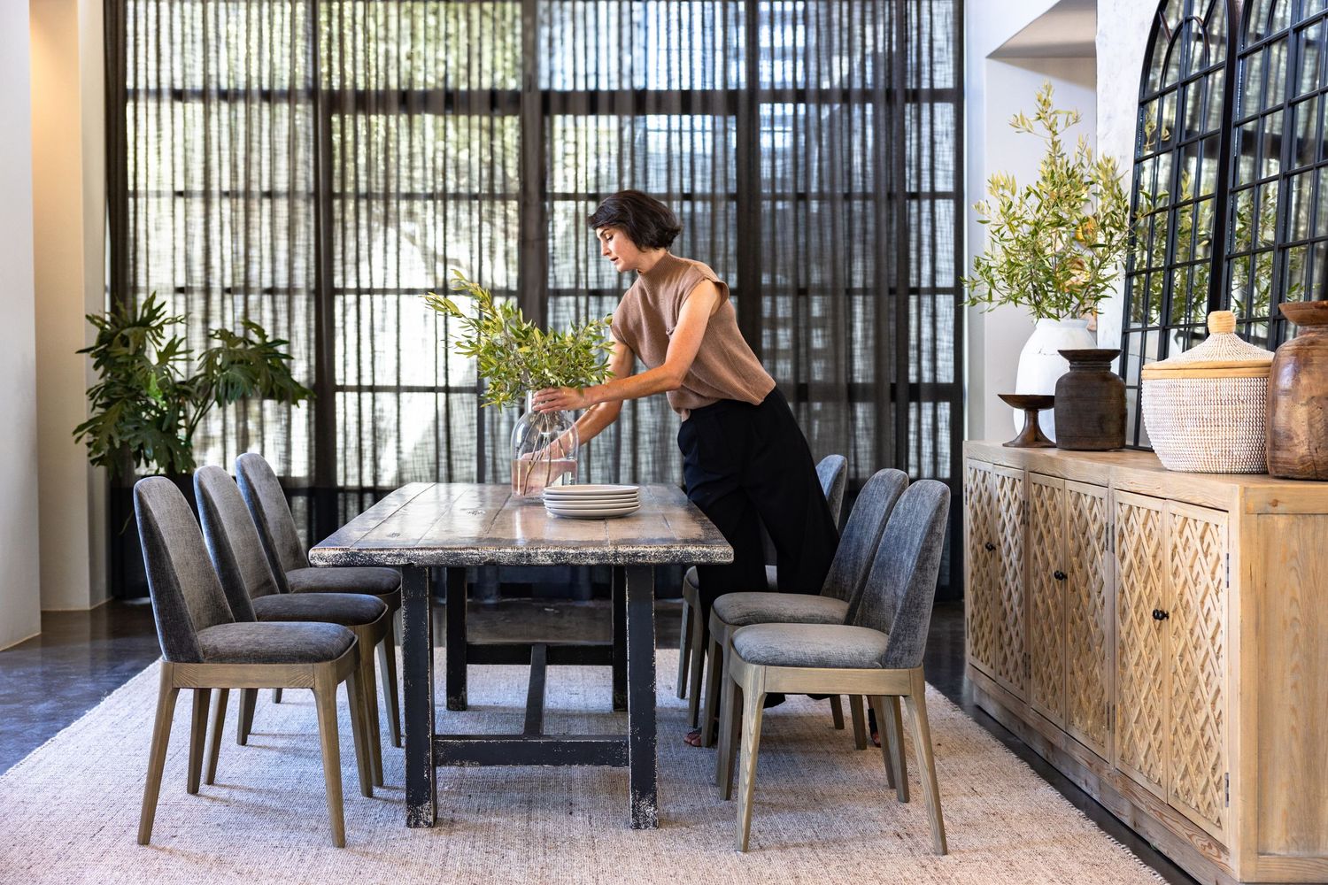 Contemporary outdoor patio space showcasing black metal railings and comfortable seating arrangements.