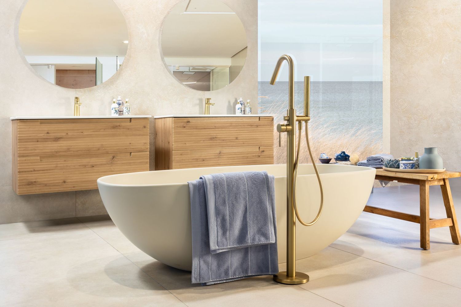 Modern bathroom interior with freestanding bathtub, wooden vanity, and minimalist design elements in neutral tones.