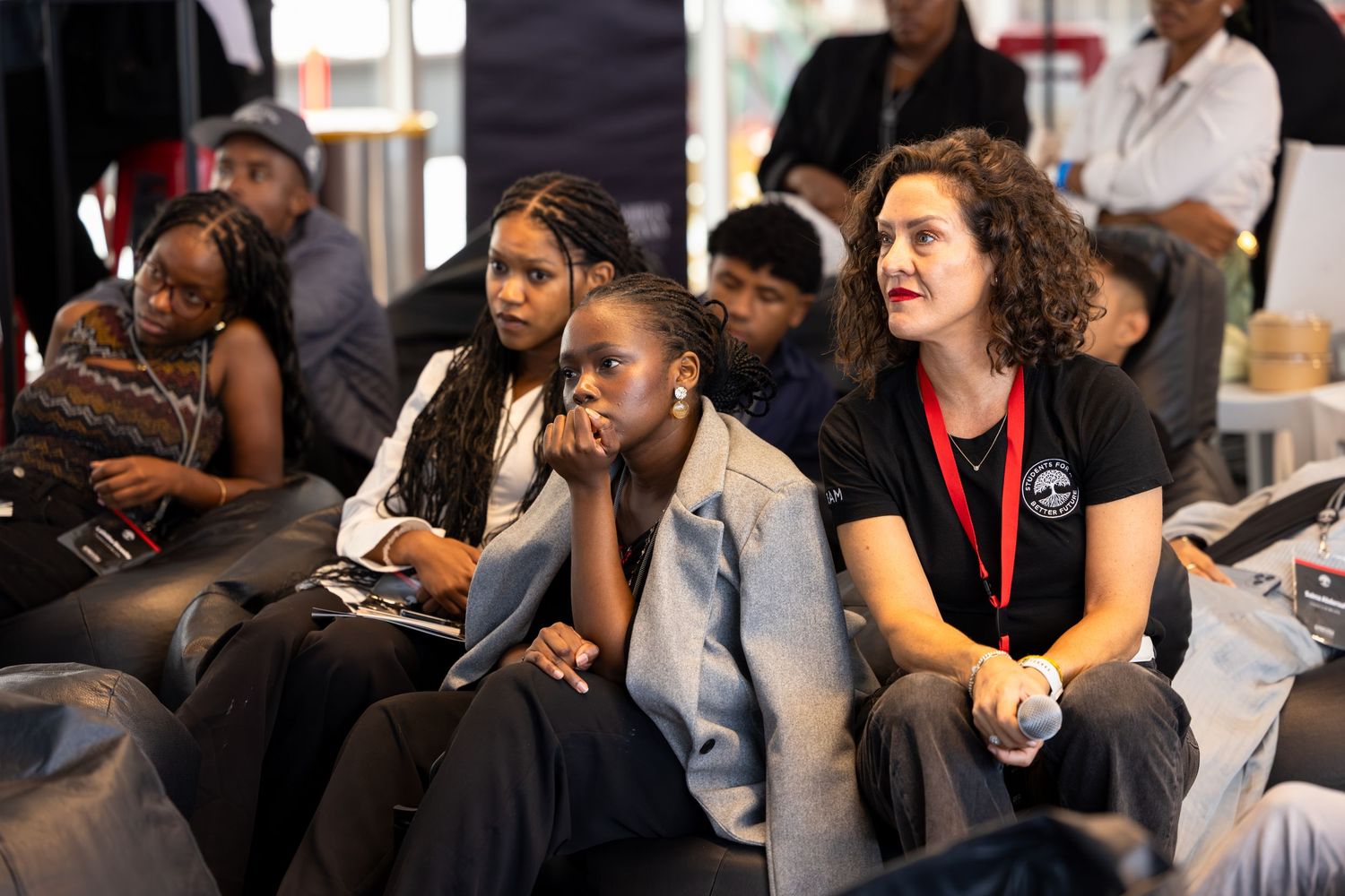 Diverse group of attendees listen intently during professional development conference session.