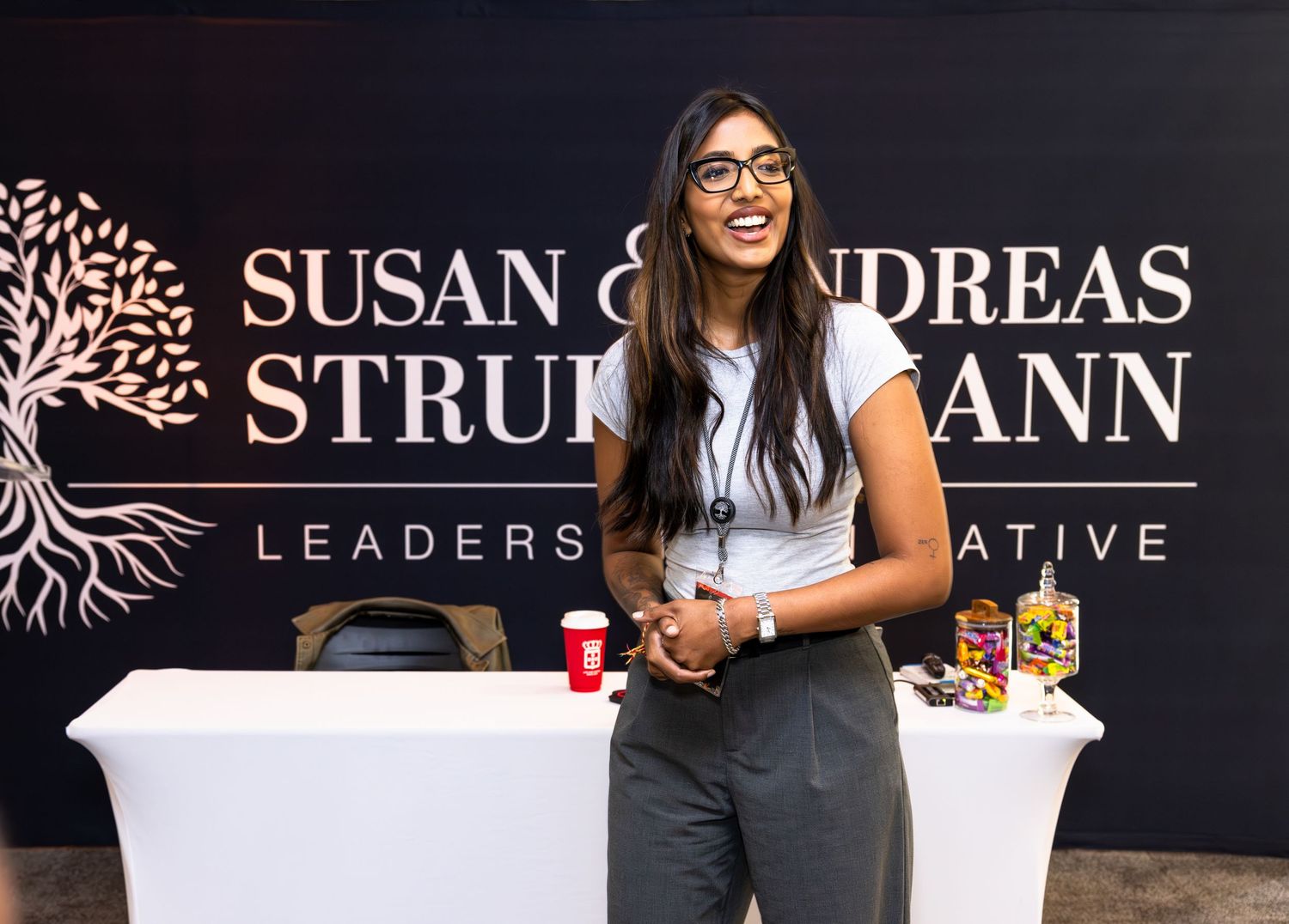 A professional conference setup with branded signage and presentation materials.