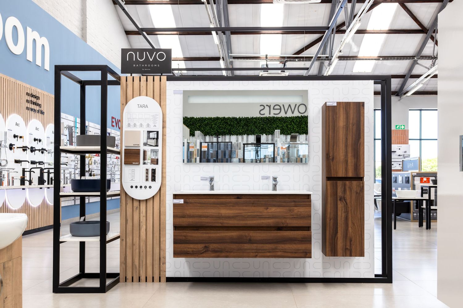Minimalist retail space showcasing bathroom fixtures with wooden accent walls and modern lighting.