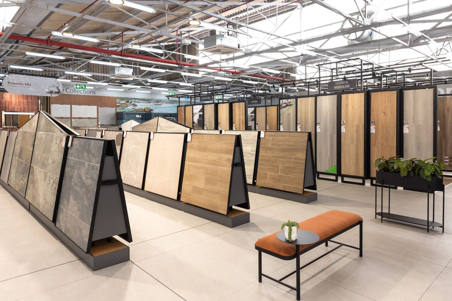 Open workspace featuring industrial ceiling, wooden cubicles, and contemporary office furniture.