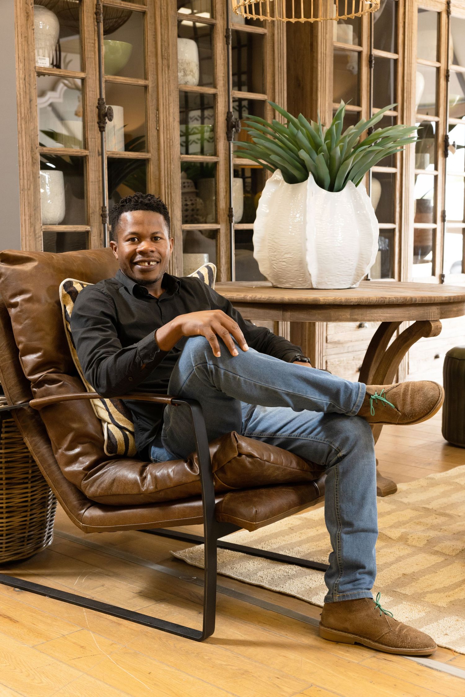 Modern leather armchair and contemporary decor create a stylish corner setting.