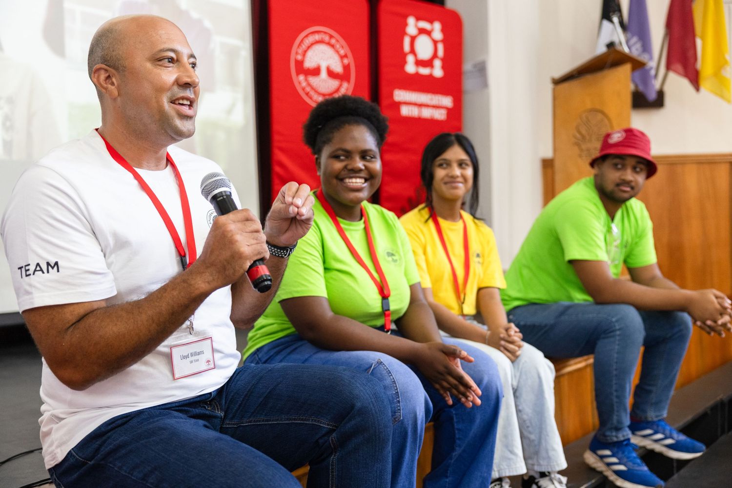 People in colorful shirts sit and discuss during a group workshop session.