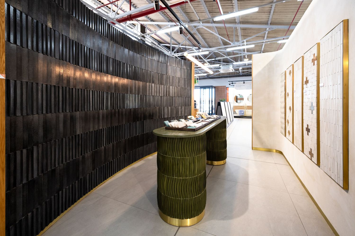 Long corridor with dark textured wall panels and recessed lighting creating a dramatic modern office hallway.