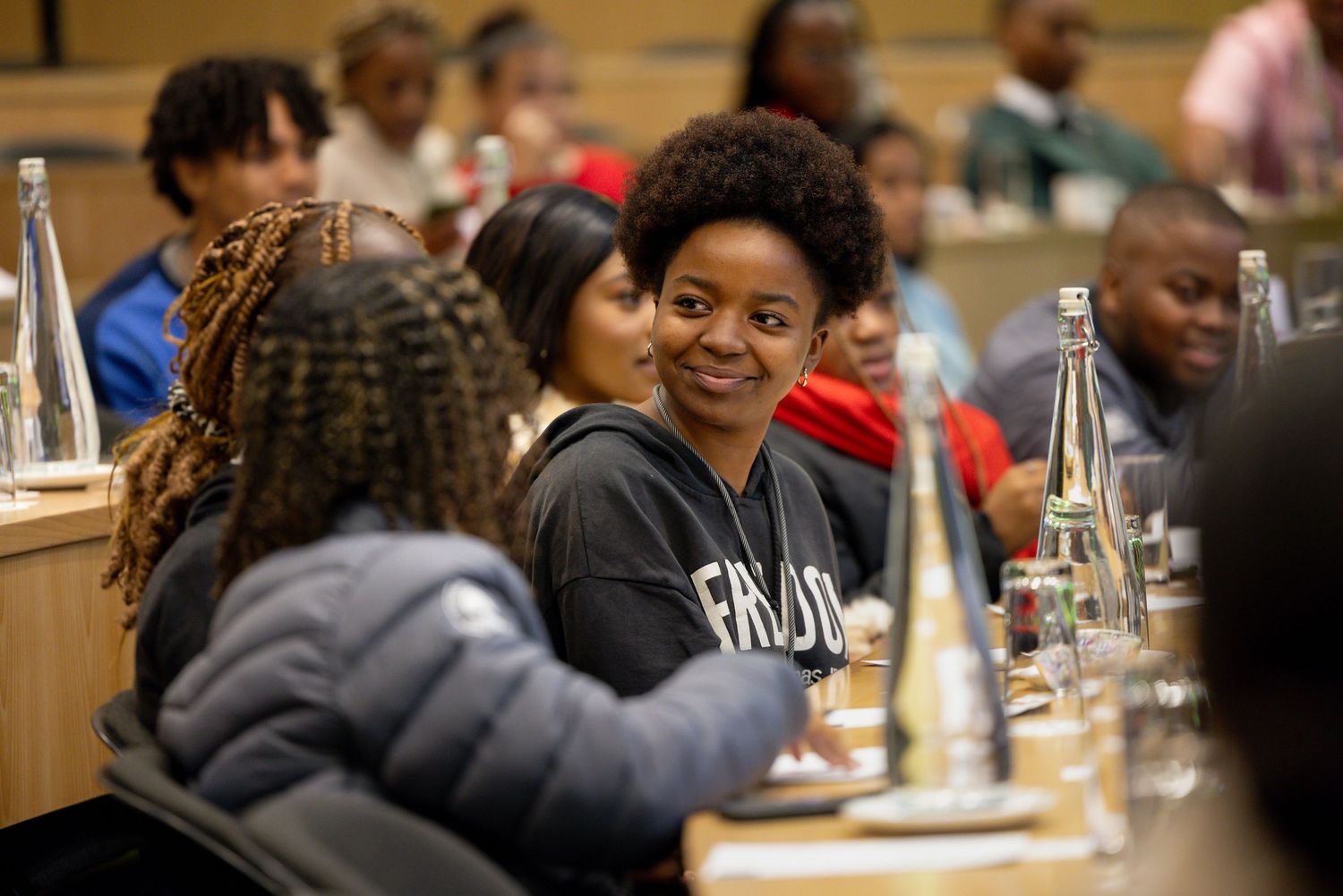 Students gathered around tables during an educational workshop or seminar.