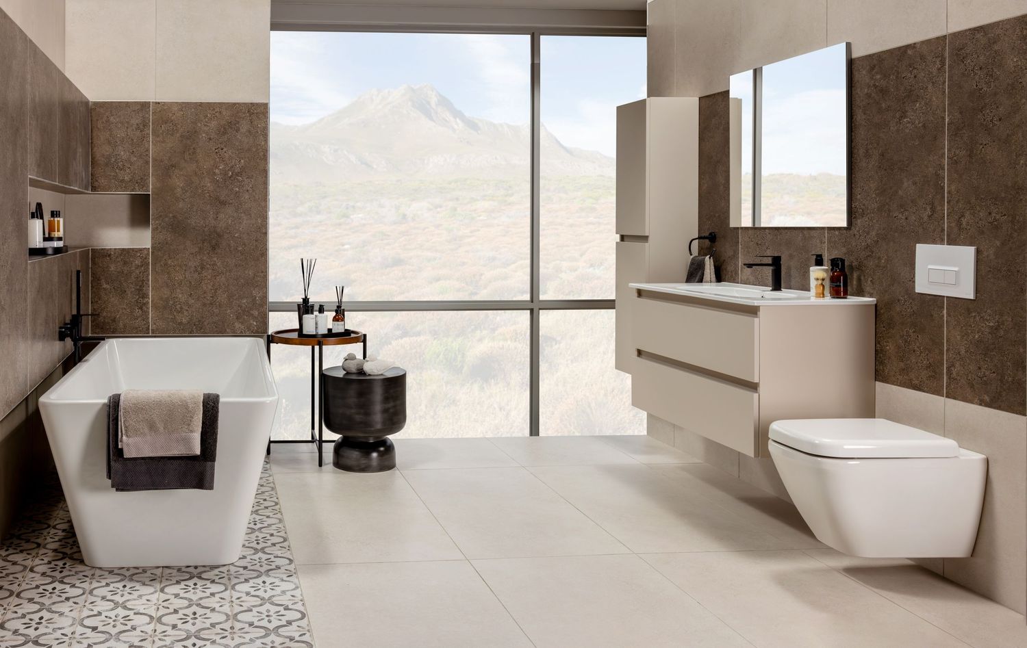 Modern bathroom with brown walls, white fixtures, and large mountain view windows showcases minimalist design.