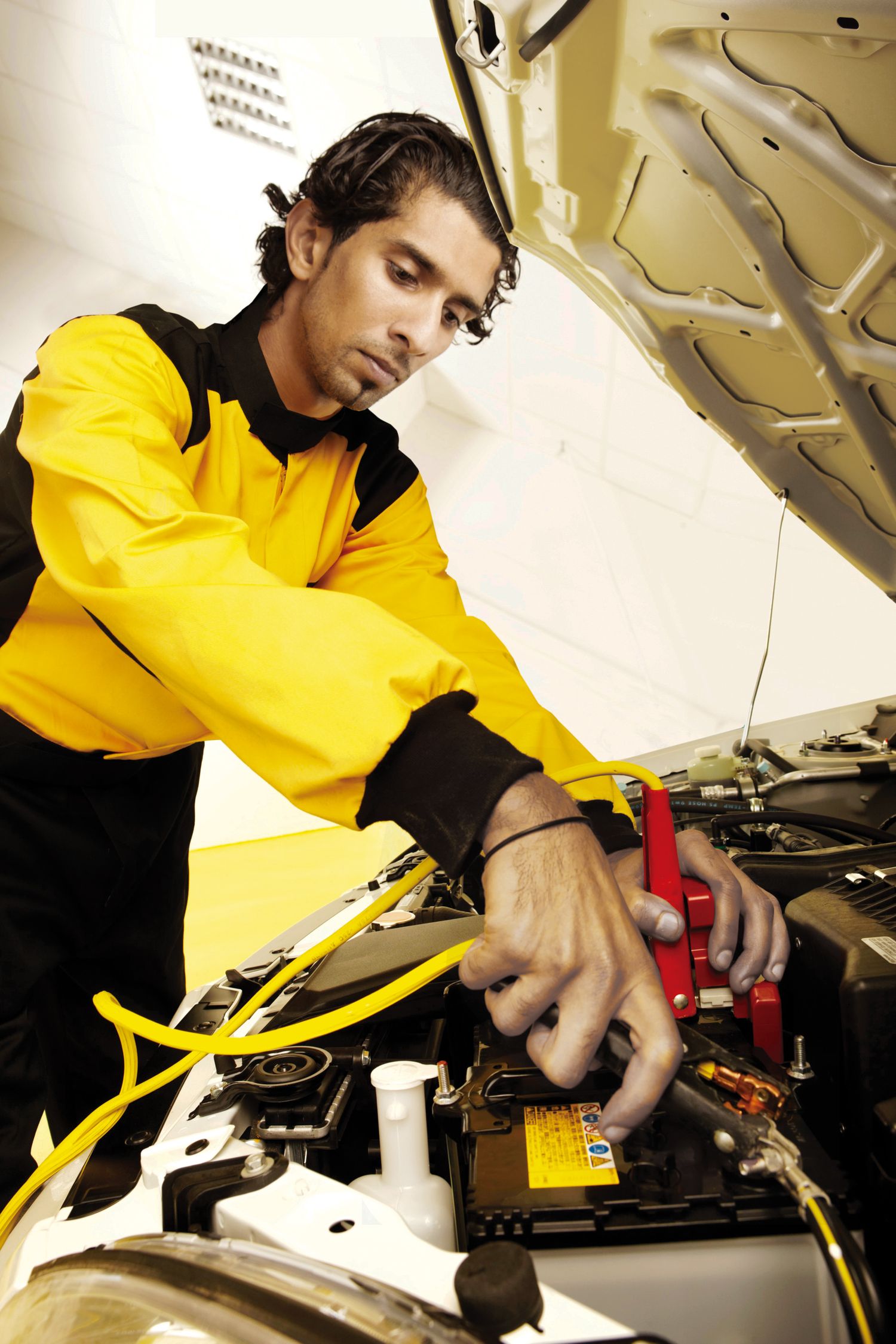 Auto technician performs detailed maintenance work on vehicle components.