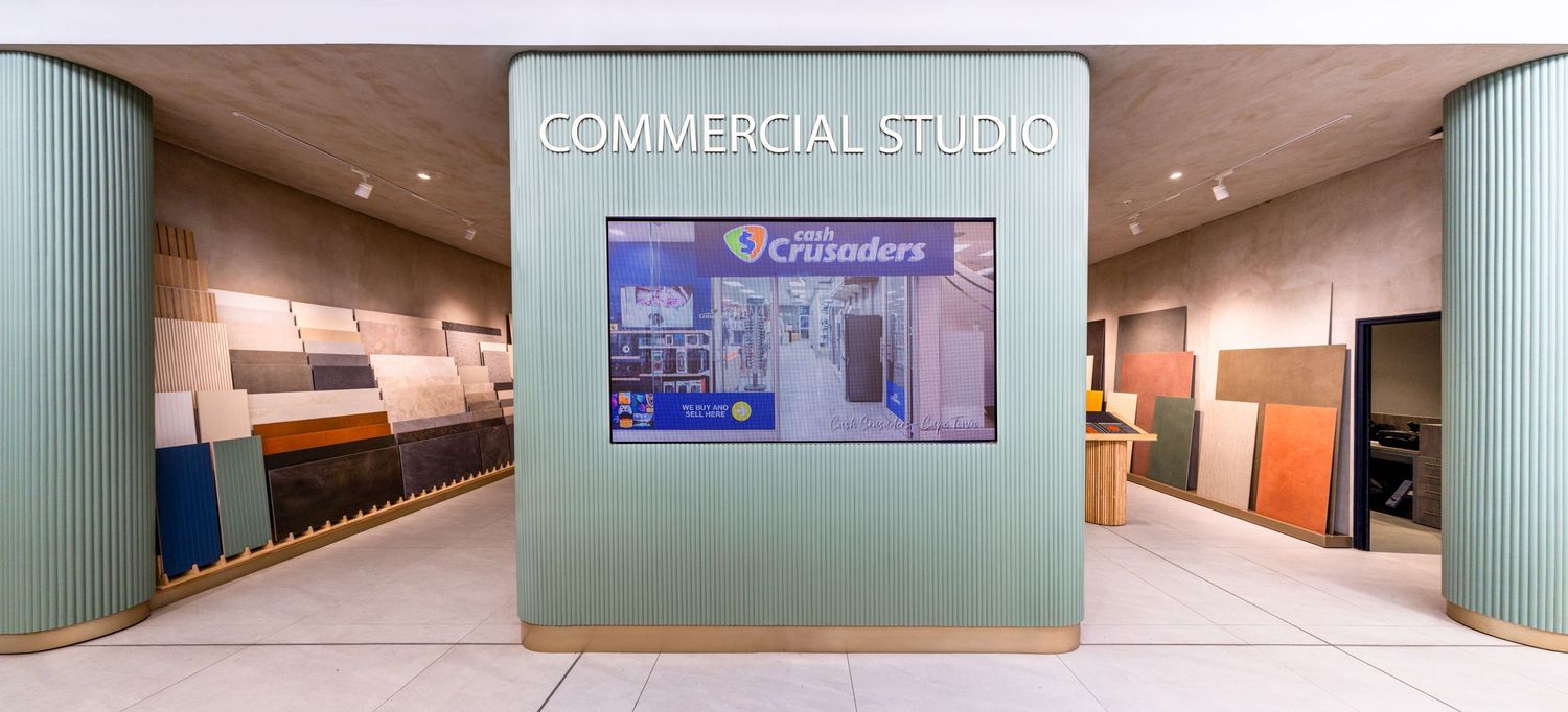 Panoramic view of a modern commercial studio space with polished floors and recessed lighting.
