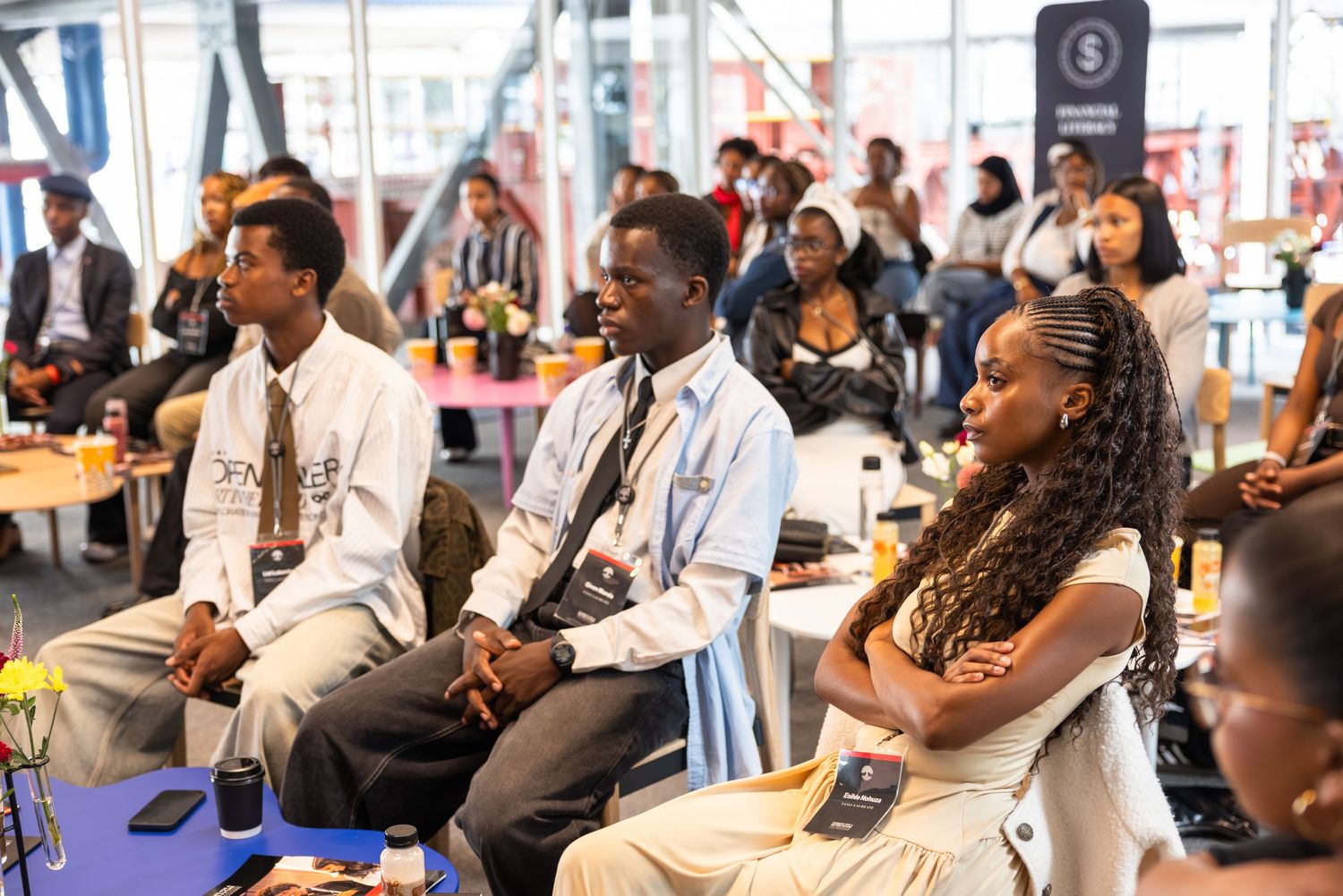 Business professionals attending a conference session in a modern meeting space.