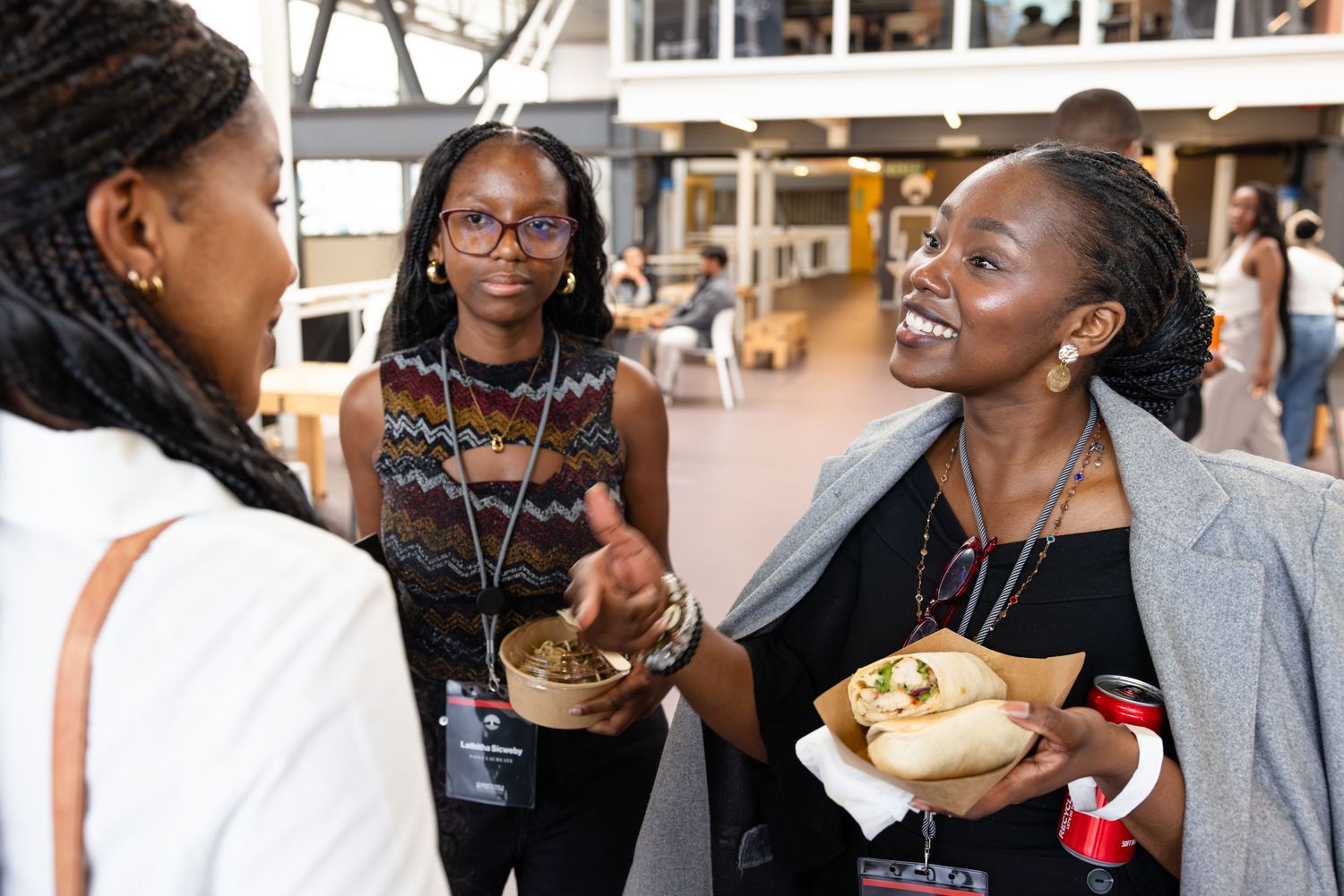 Attendees network and share refreshments during a professional conference break.