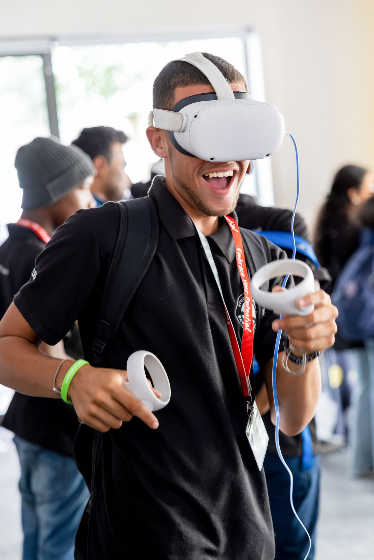 People experiencing virtual reality with Oculus headsets at a tech event.