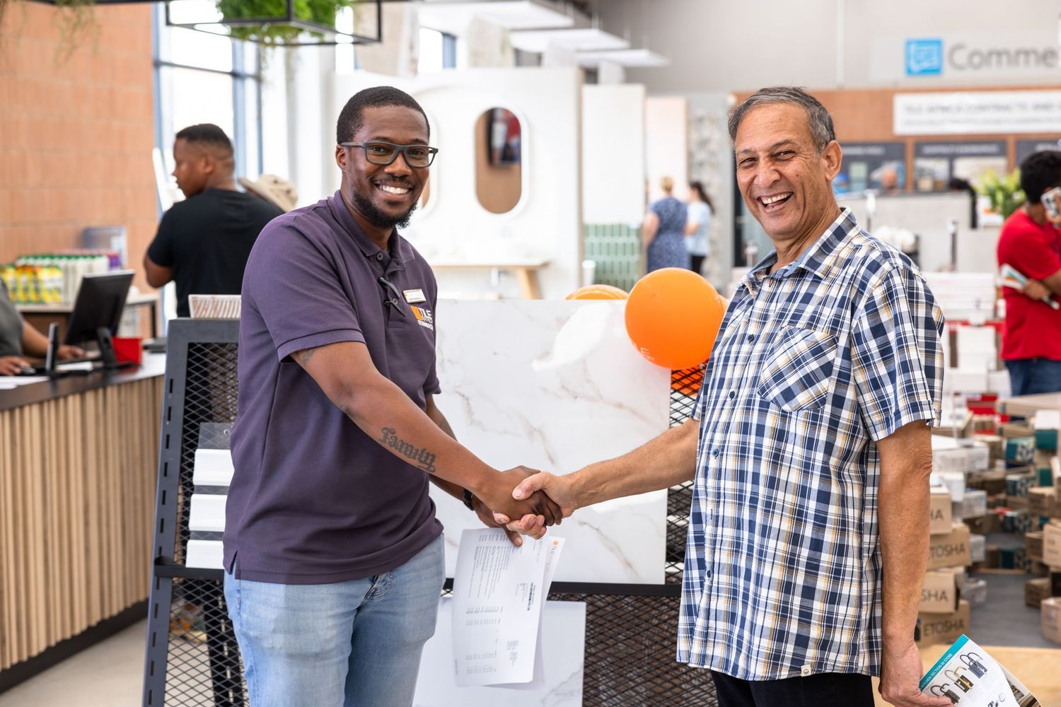 People networking and shaking hands at a business event.