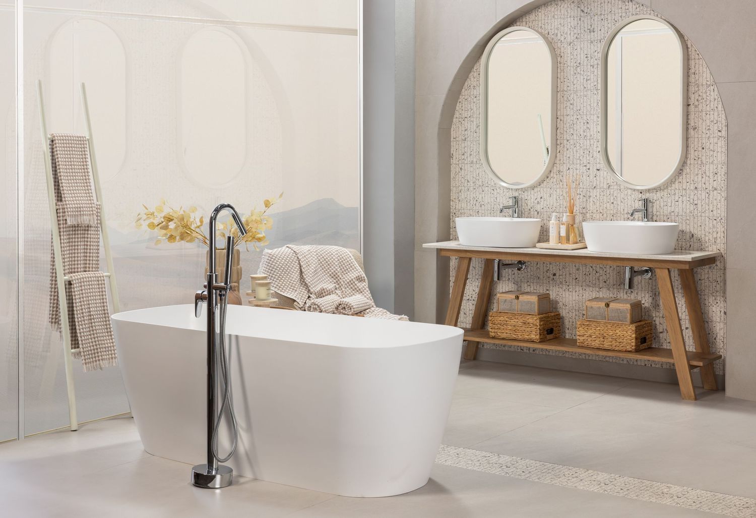 Clean modern bathroom featuring oval mirrors, white vessel sinks, and natural wood elements.