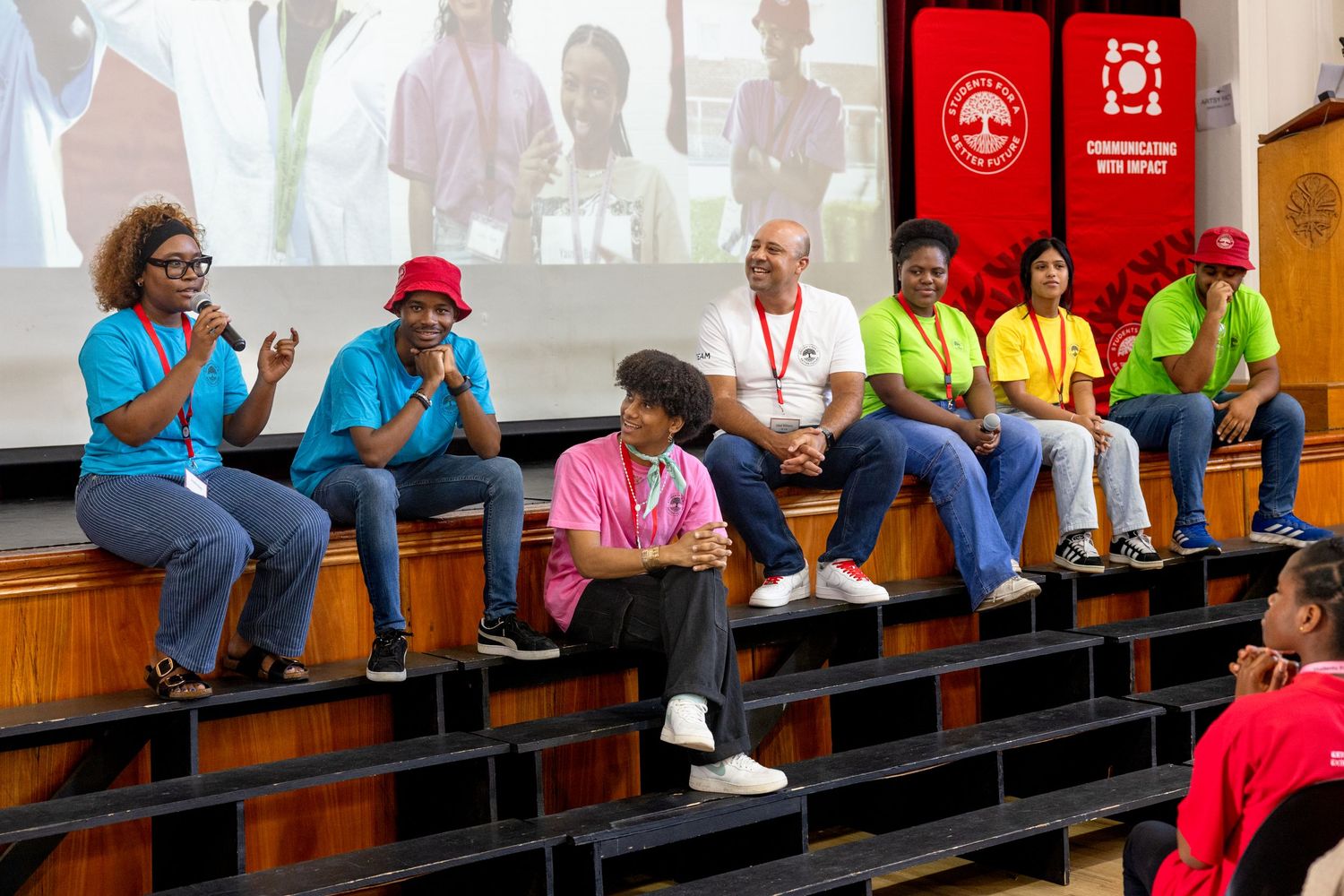 Participants seated in tiered rows during an educational event.