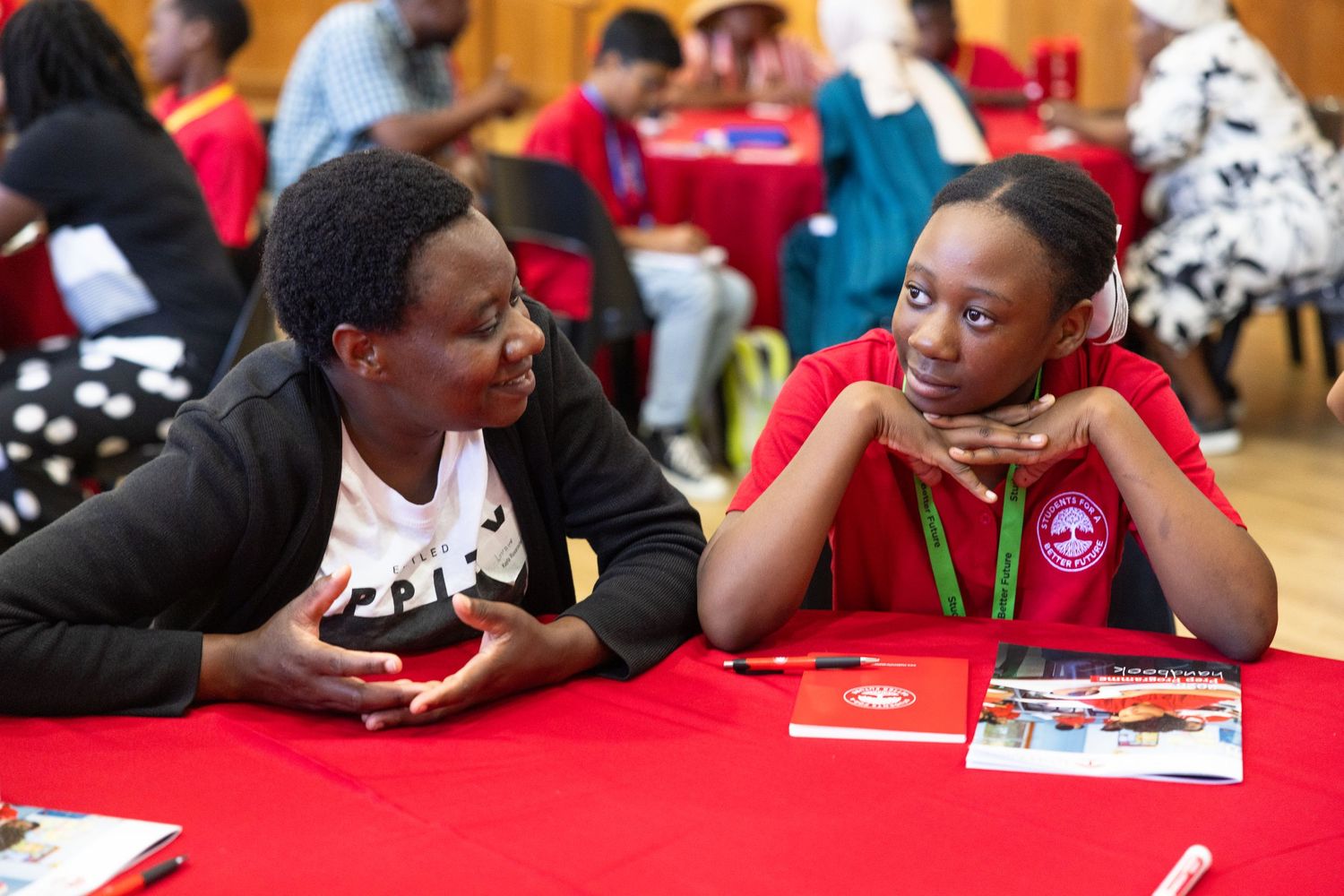 Students engaged in activities at tables during an educational workshop.