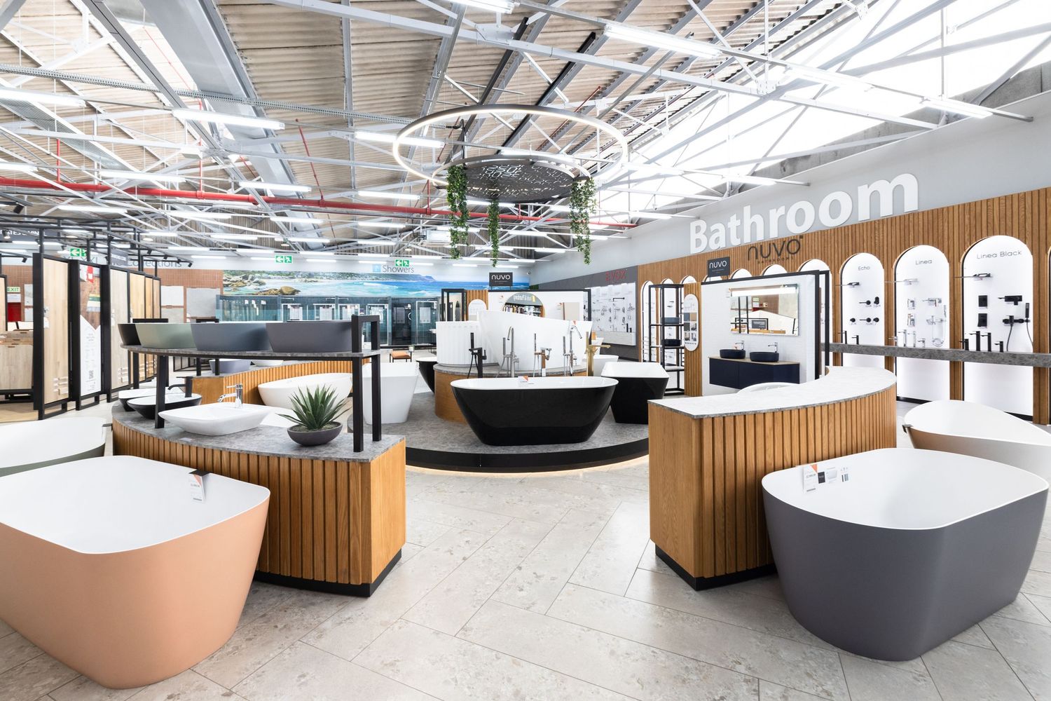 Modern office interior with curved reception desks and sleek wooden paneling in an open industrial-style space.