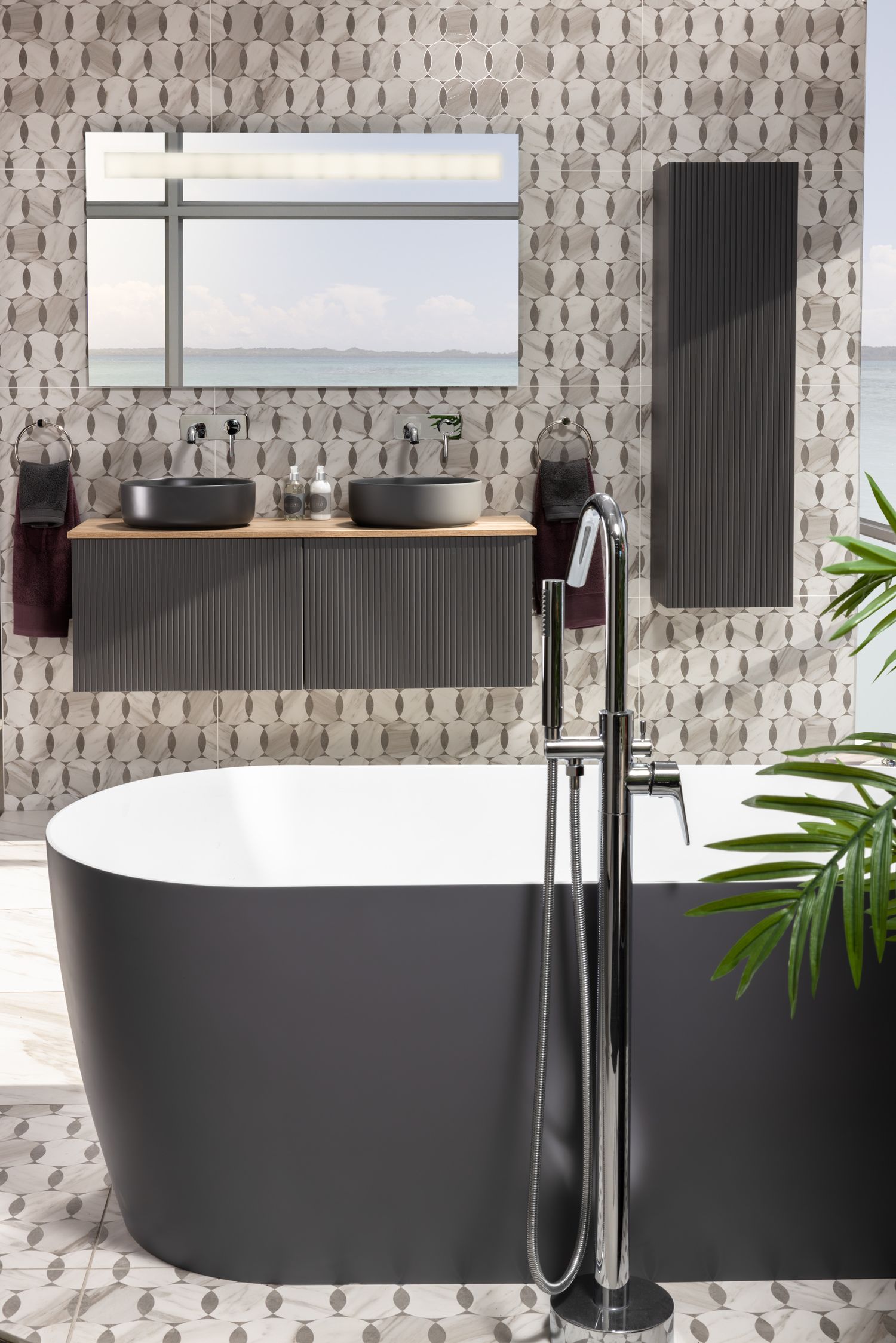 Modern bathroom interior with black freestanding tub and floating vanity.