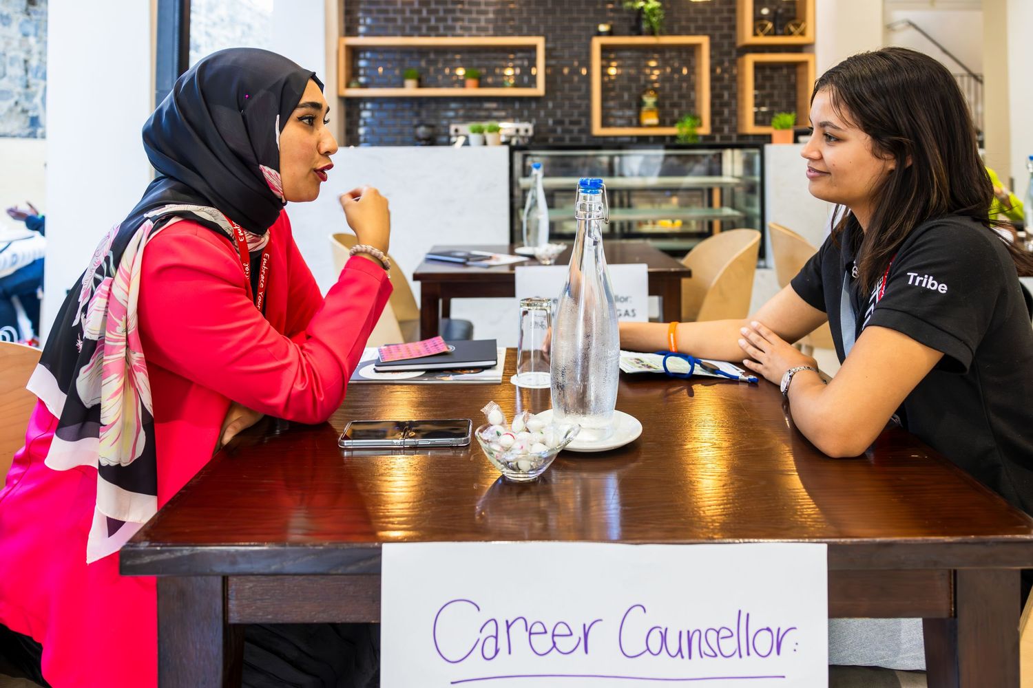 Group discussions taking place at tables during a career counseling event.