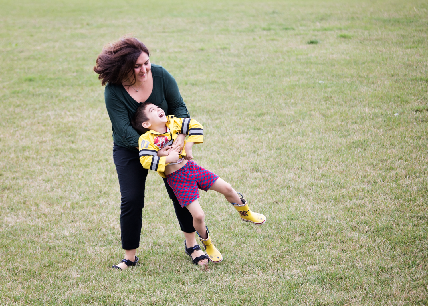 Playful outdoor scene with people on grassy field.