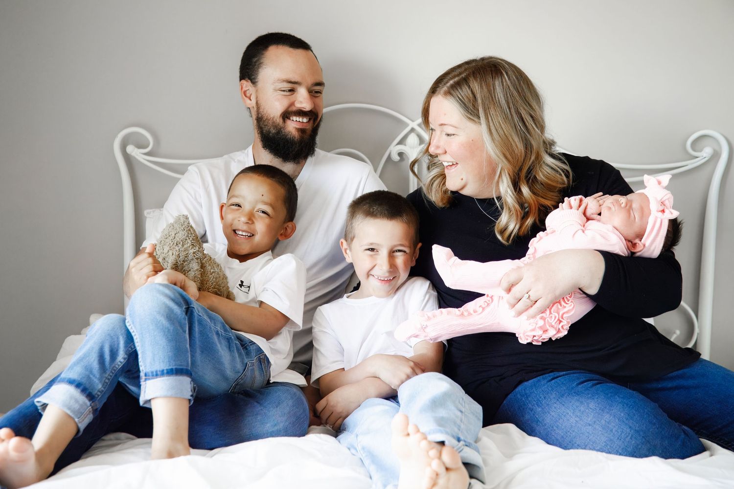 A series of candid family moments showing parents and children relaxing together on a bed.