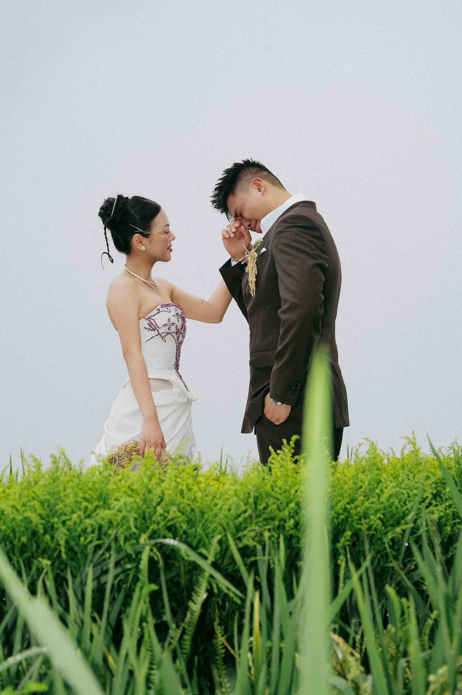 wedding: romantic wedding portraits captured in a lush green field against a bright sky, by AnhVuWedding.