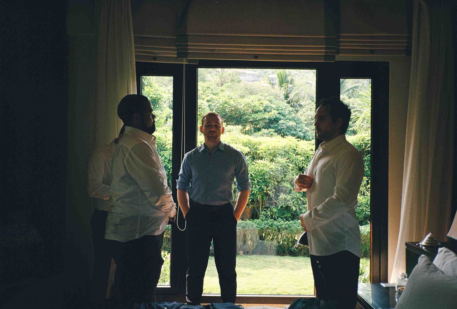 Lang Co wedding: group gathered in a room with large windows overlooking green outdoor scenery, by AnhVuWedding.
