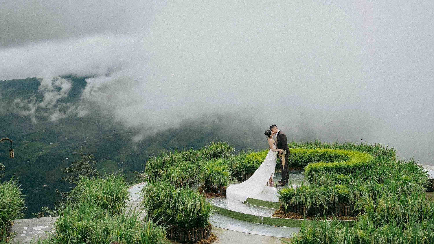 wedding: panoramic view of a misty mountain landscape with green vegetation, by AnhVuWedding.