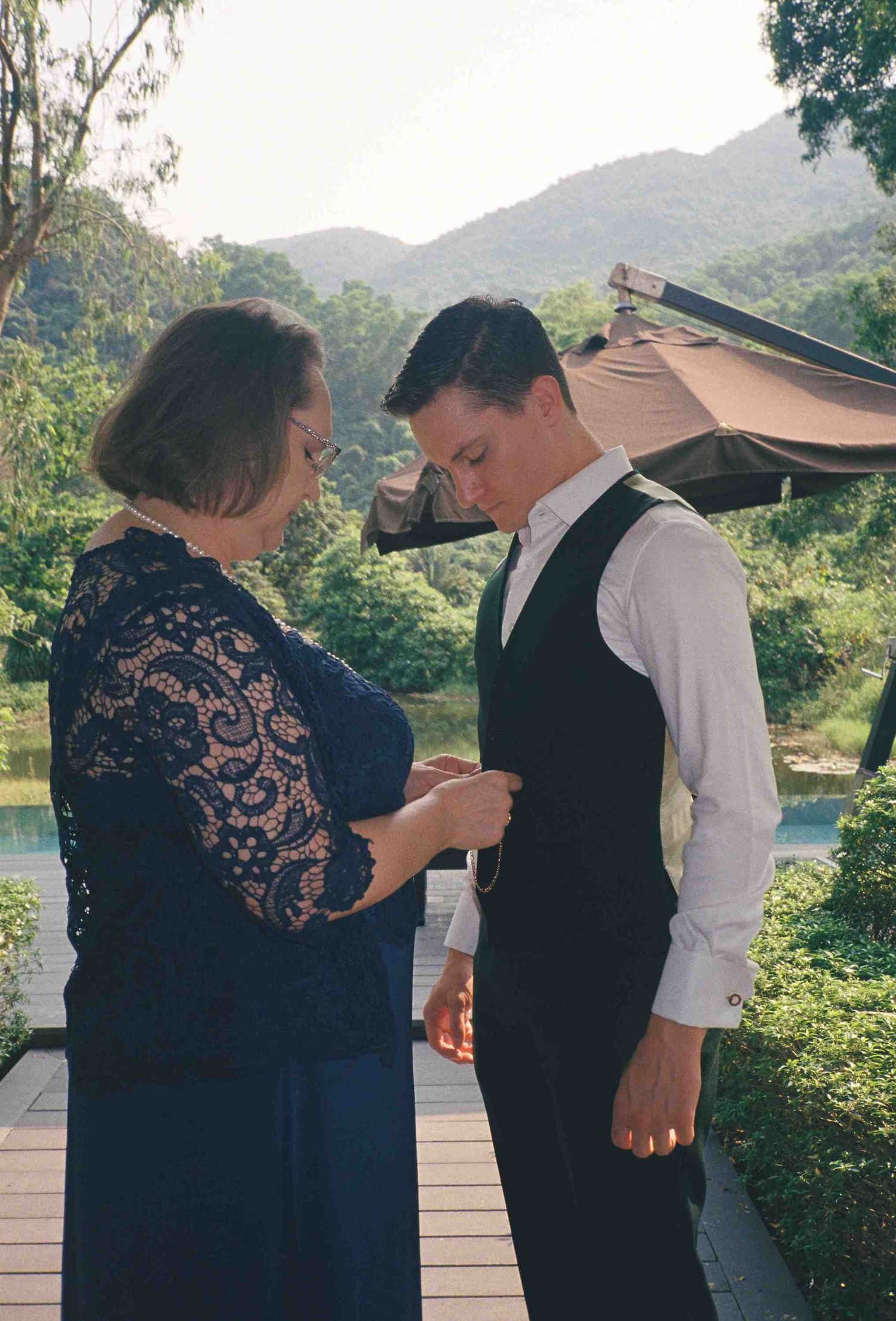 Lang Co wedding: wedding preparations taking place on an outdoor deck with mountain views, by AnhVuWedding.