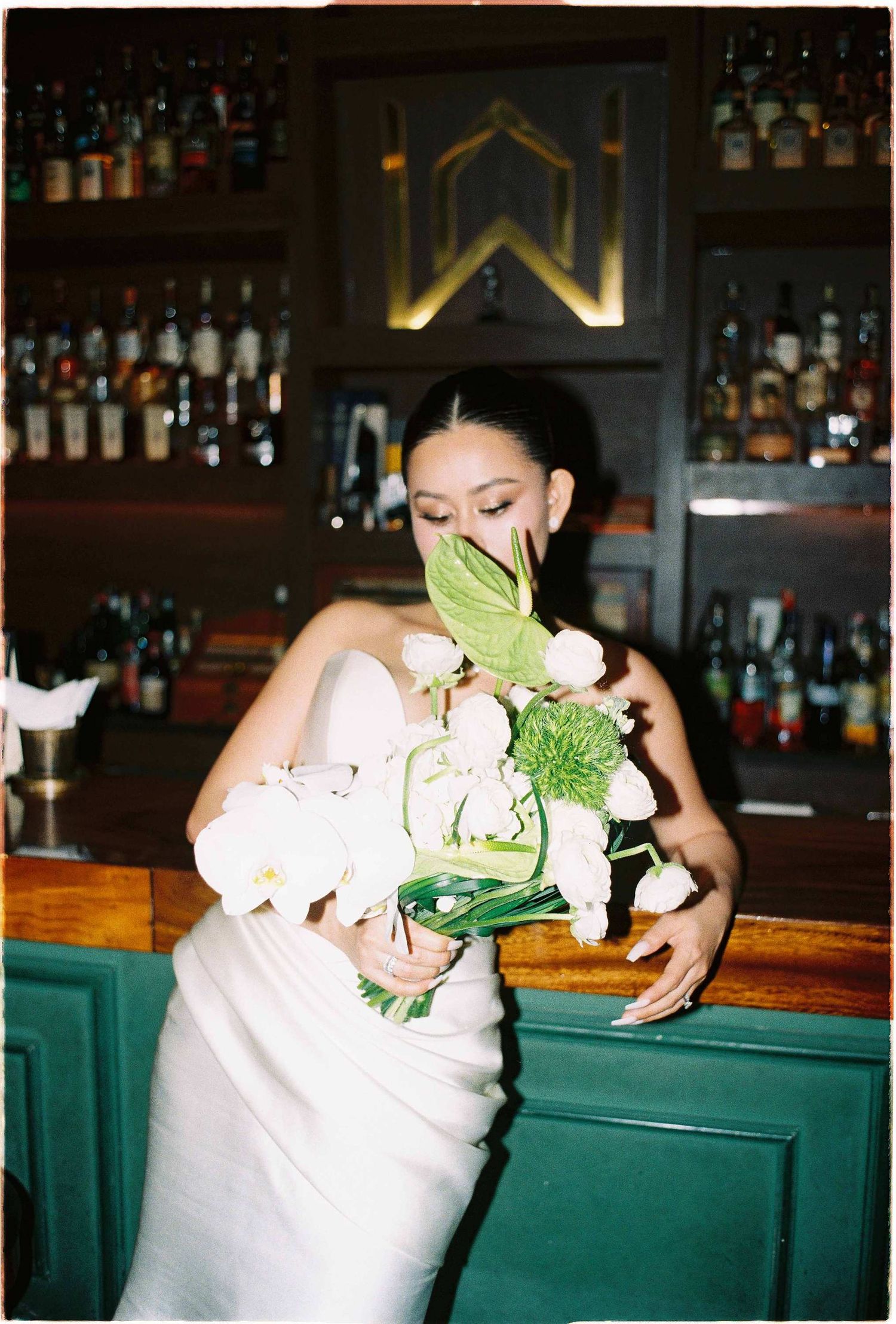 Vietnam pre-wedding: wedding reception scene at bar with white flowers and green decor, by AnhVuWedding.