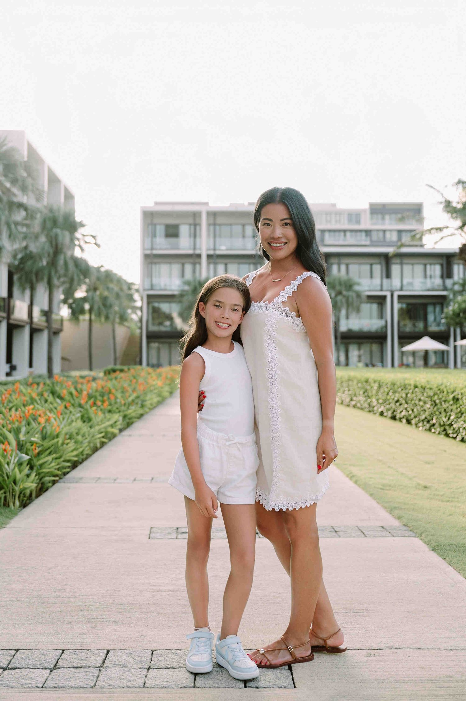 Da Nang family: family bonding during a summer photoshoot on a palm-lined pathway, by AnhVuWedding.