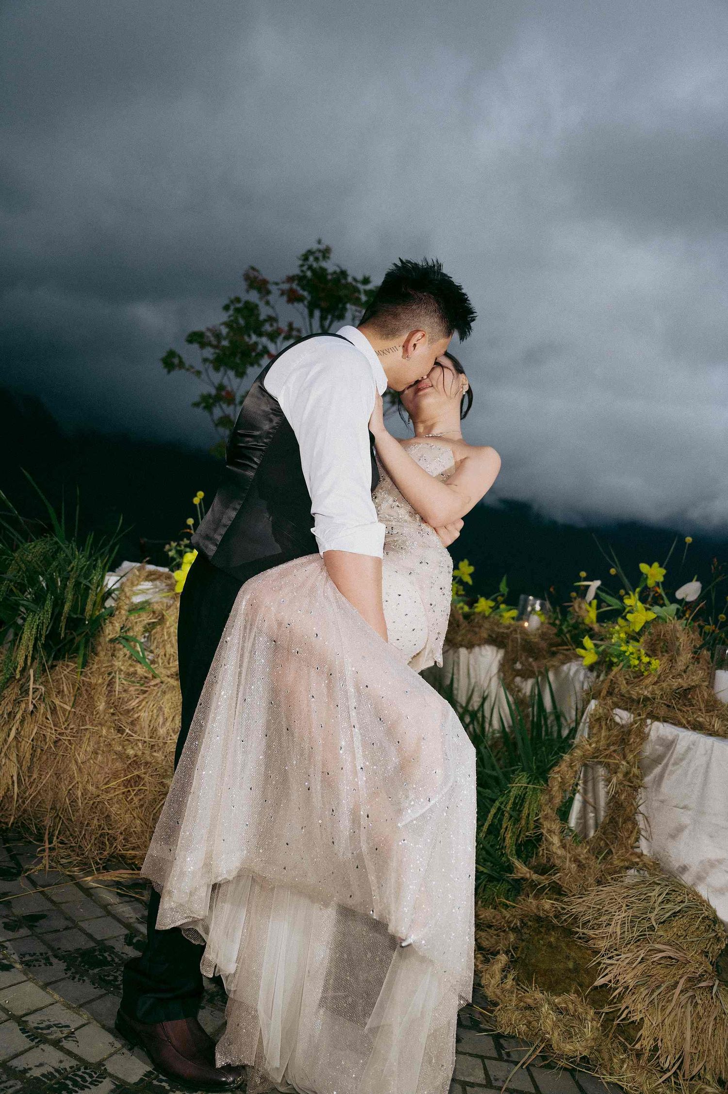 wedding: romantic wedding photoshoot with a couple embracing under stormy skies in a natural outdoor setting, by AnhVuWedding.