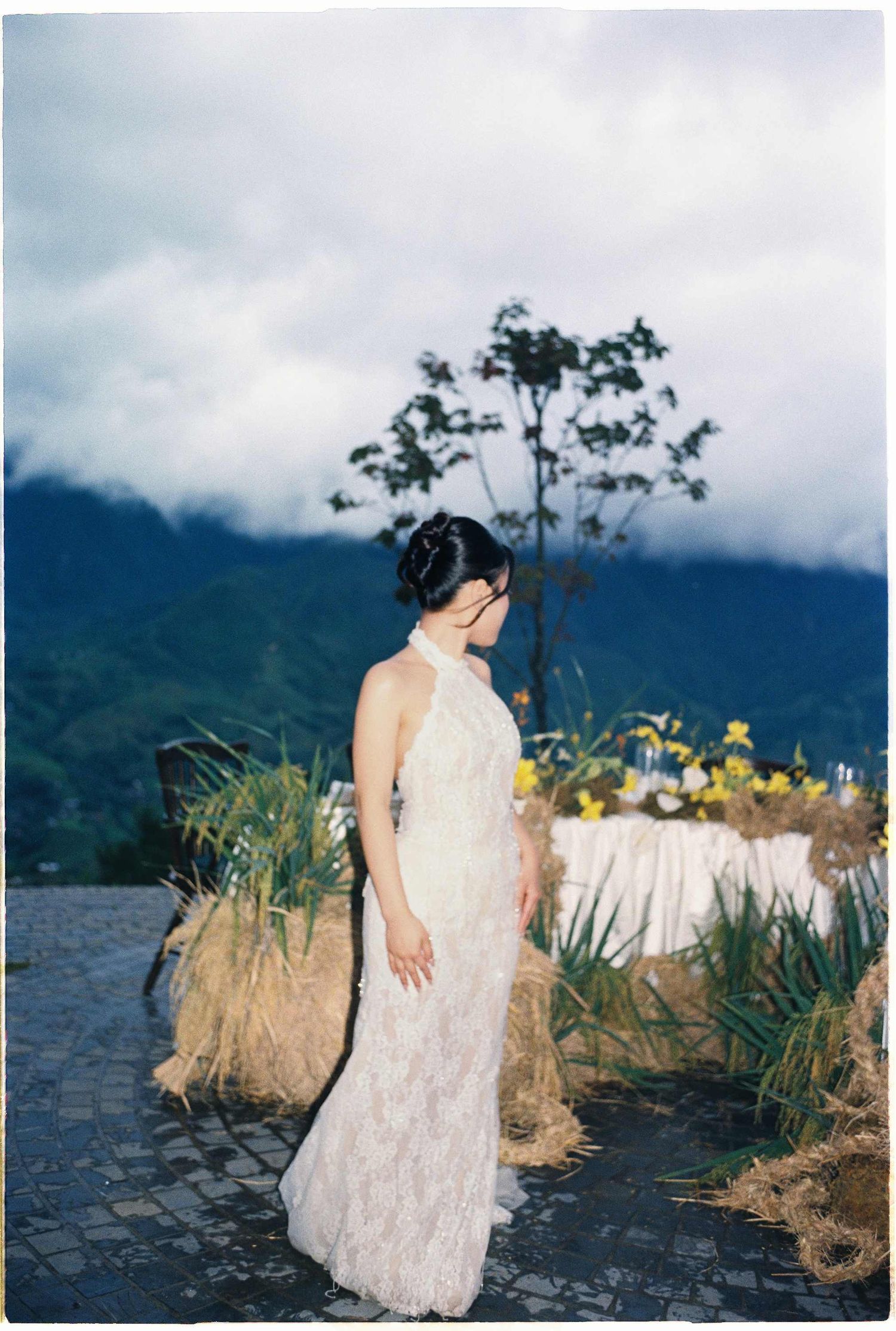 ride standing gracefully in front of Sapa’s mountains, elegant destination wedding photography in Vietnam.