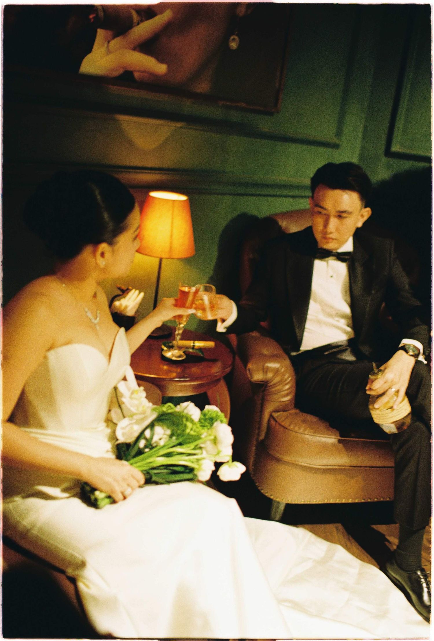 Vietnam pre-wedding: couple in formal attire sharing drinks at intimate table setting, by AnhVuWedding.