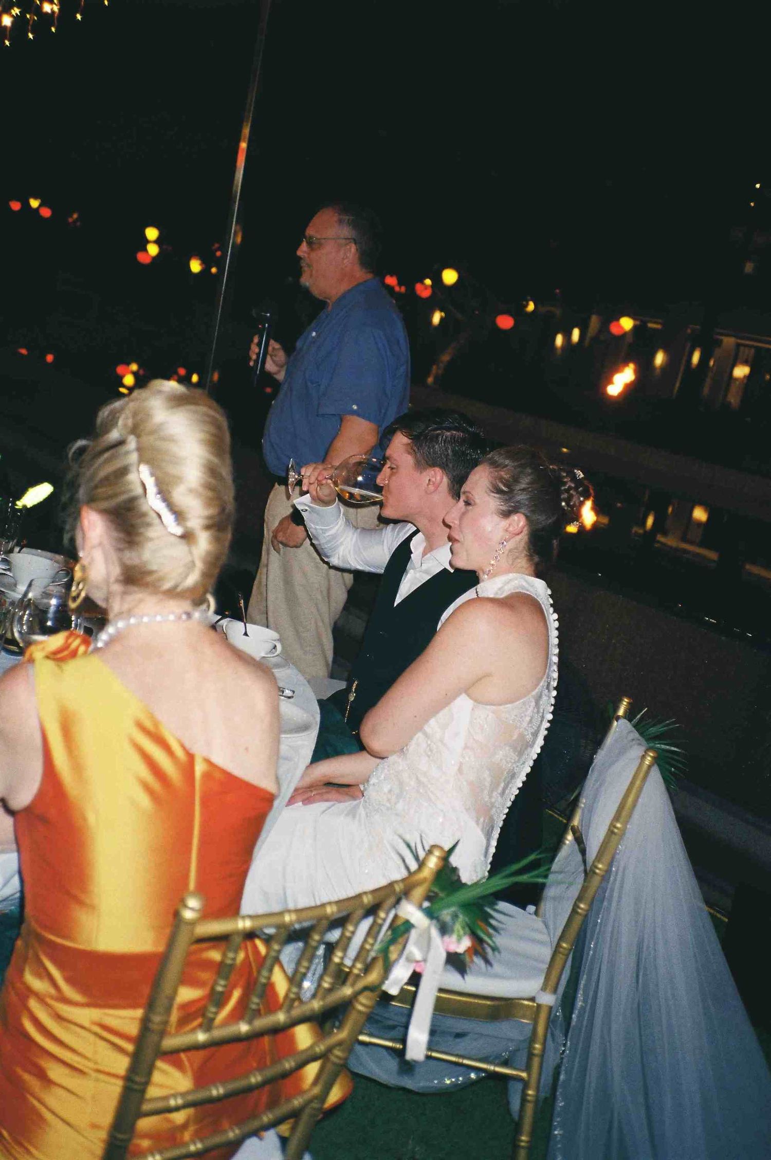Lang Co wedding reception: wedding guests socializing at outdoor reception tables under twinkling lights, by AnhVuWedding.