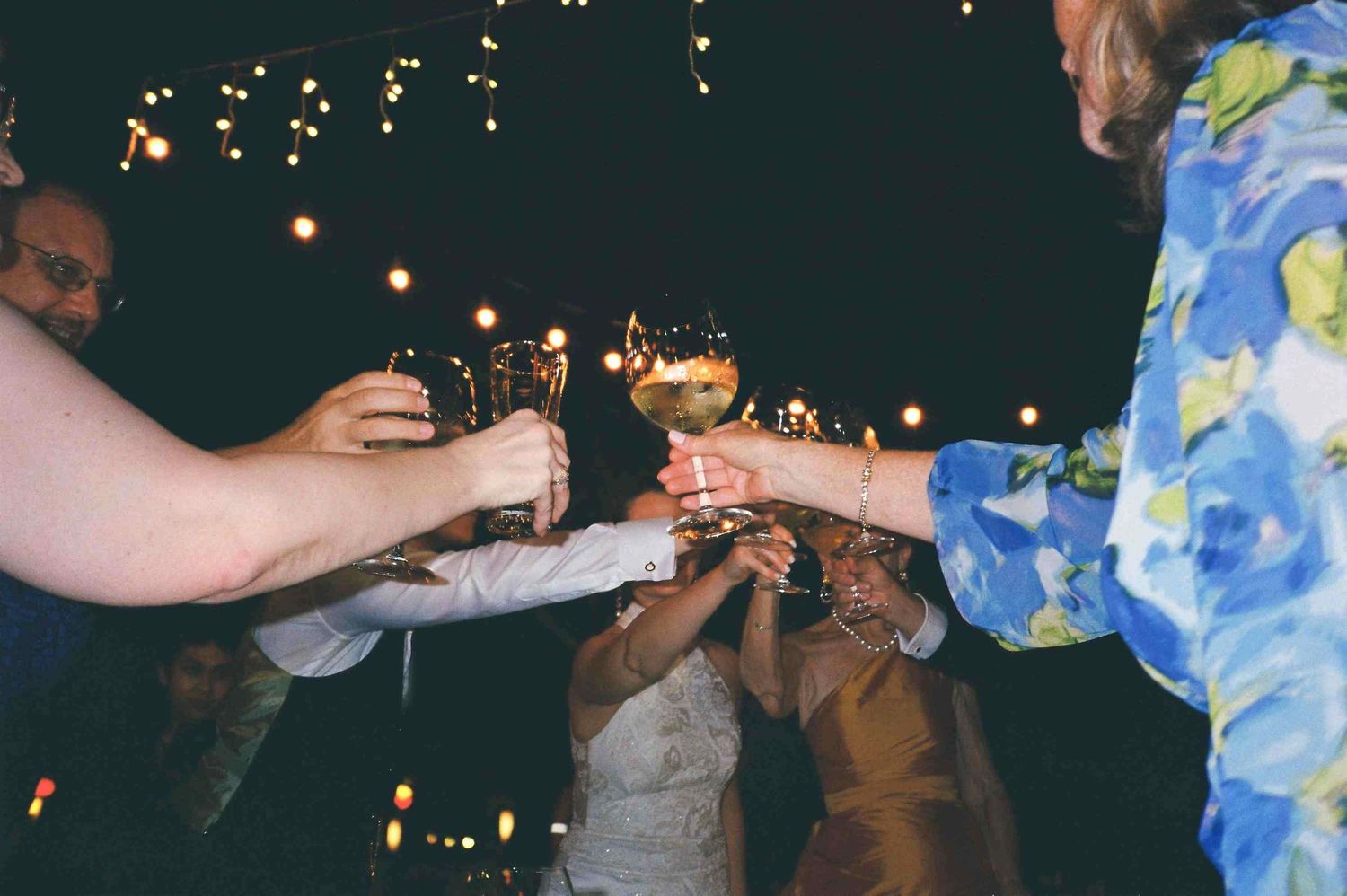 Lang Co wedding reception: evening wedding reception with guests seated at decorated tables under string lighting, by AnhVuWedding.