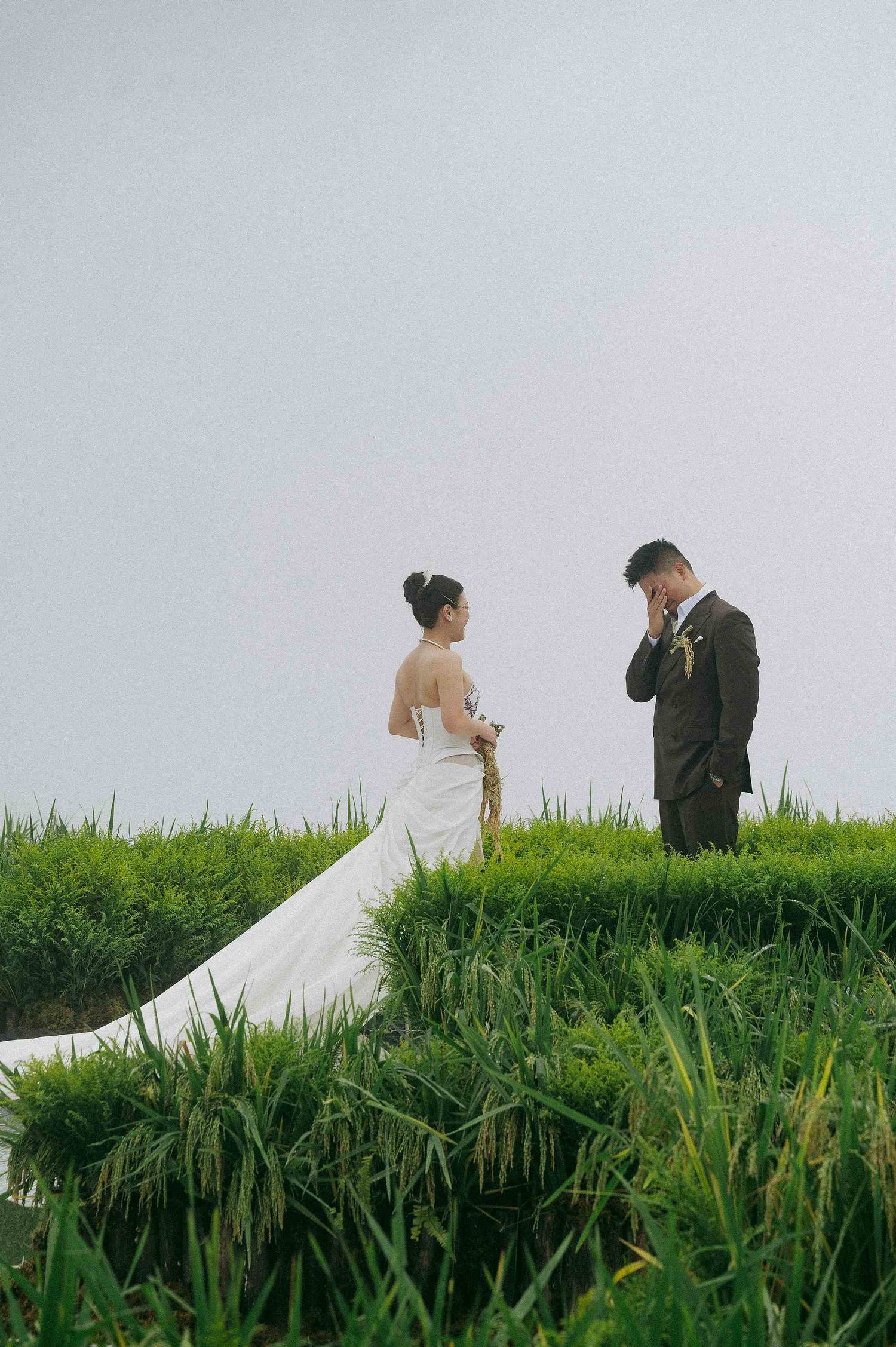 wedding: wedding couple walking through a scenic path surrounded by tall green grass and natural landscape, by AnhVuWedding.
