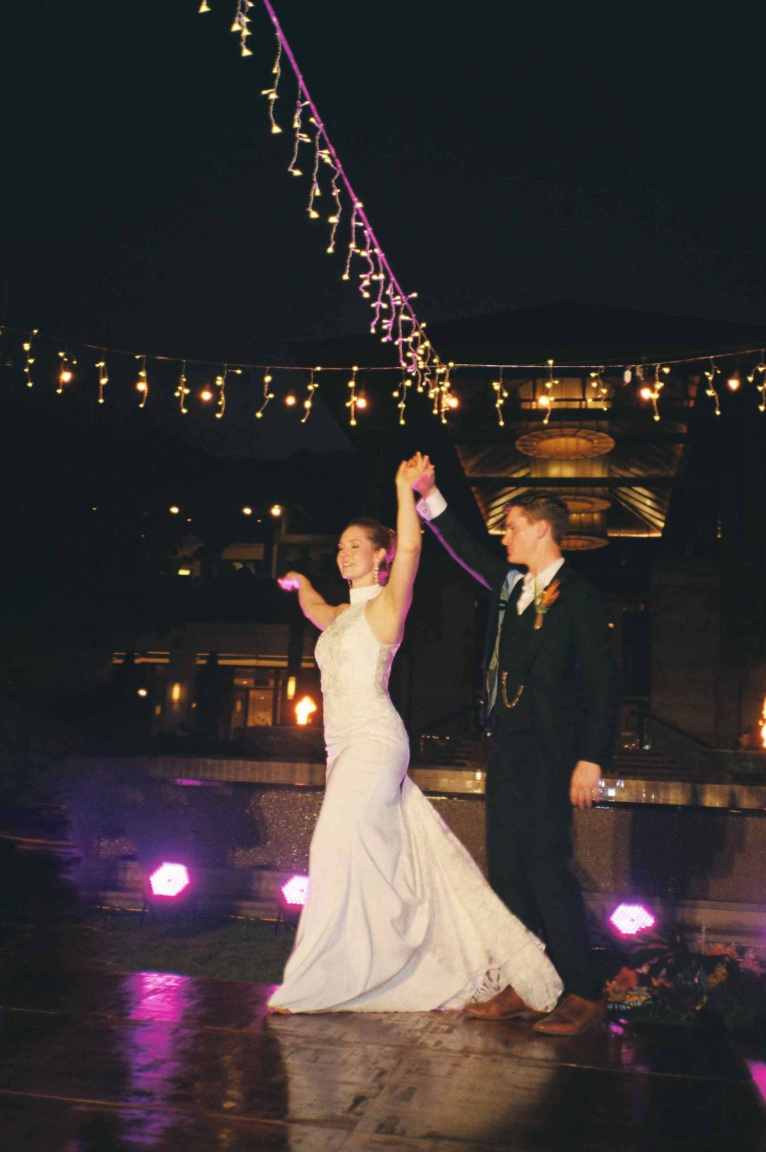 Lang Co wedding reception: newlyweds performing a choreographed dance routine under twinkling lights at their outdoor, by AnhVuWedding.