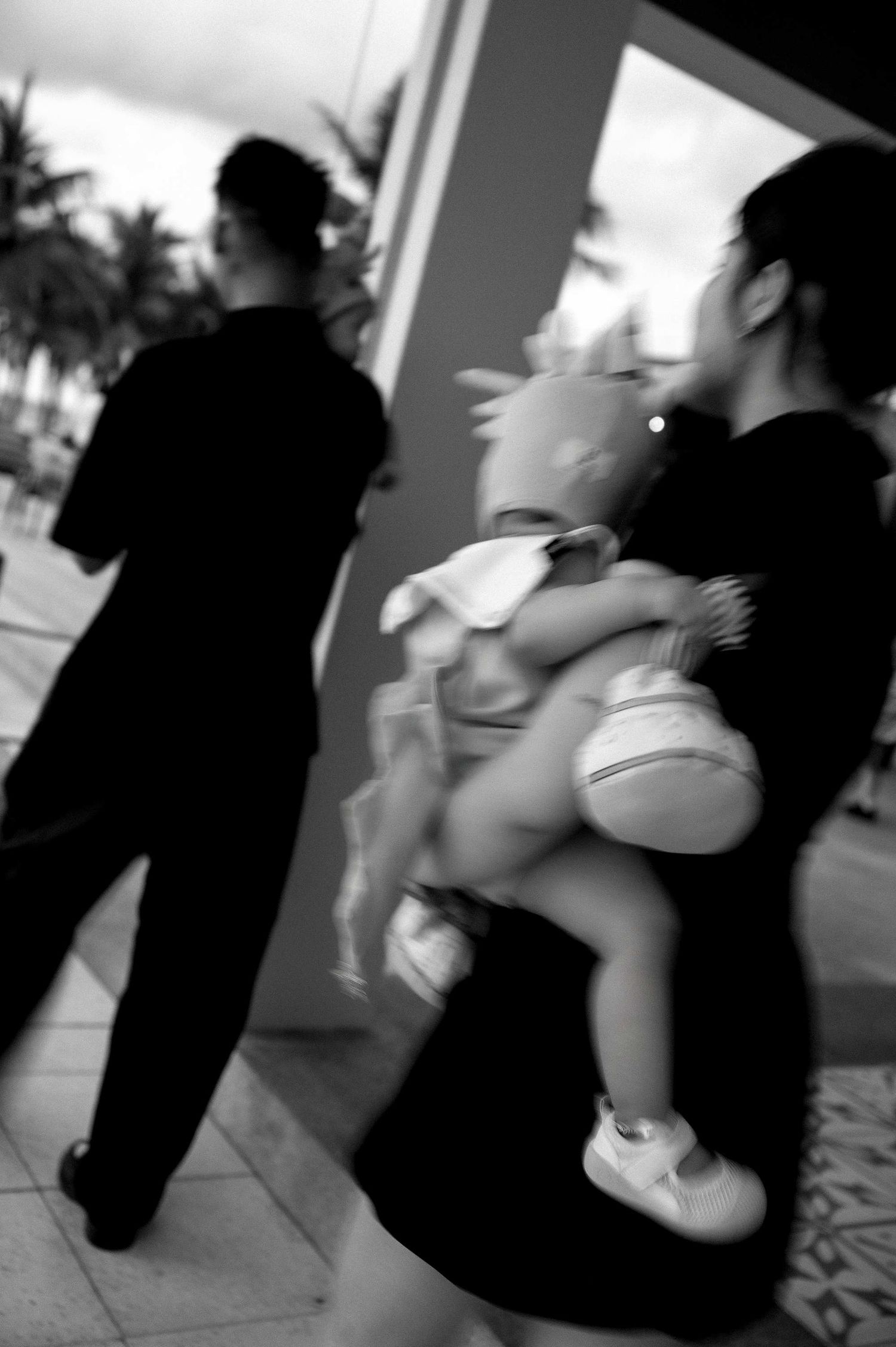 Da Nang family: family shares an intimate moment together on a tropical resort walkway, by AnhVuWedding.