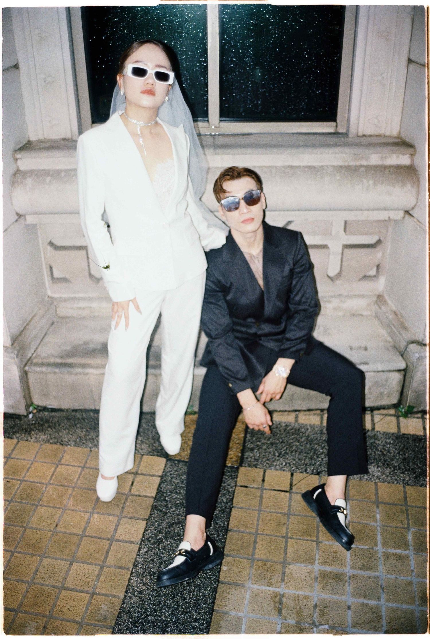 Saigon pre-wedding: two people in contrasting outfits pose on tiled steps in an artistic composition, by AnhVuWedding.