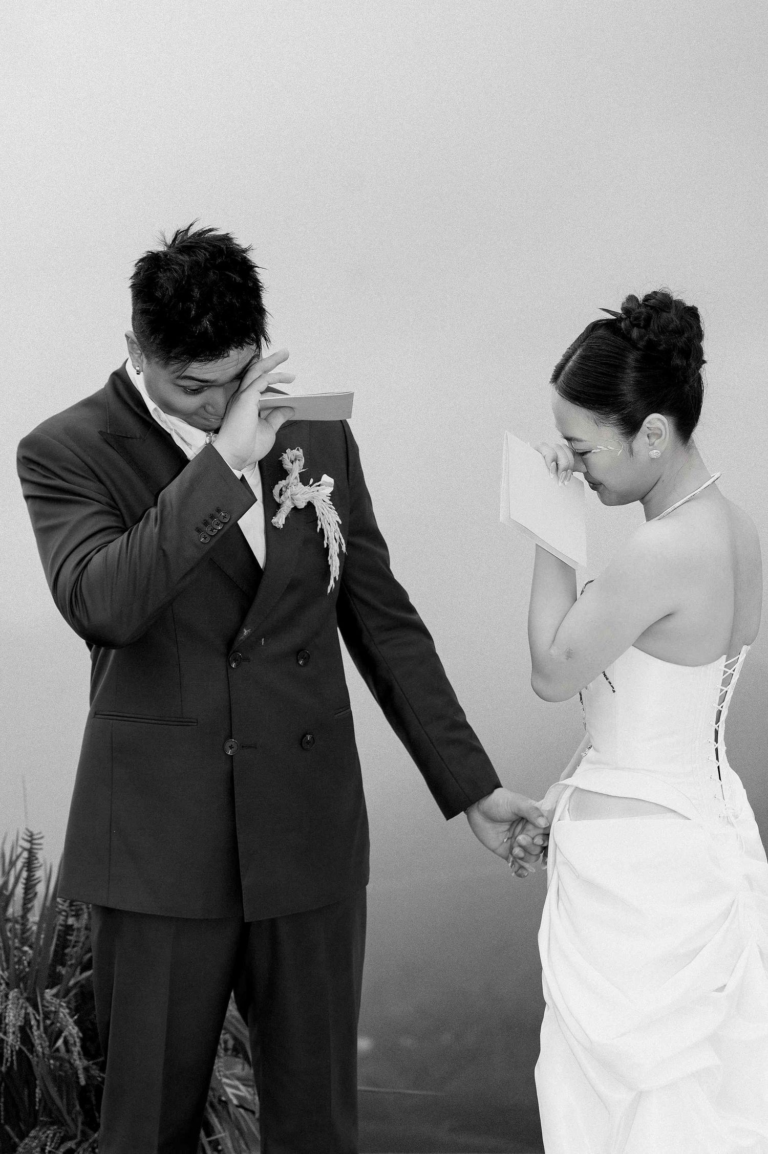 wedding: black and white photo series showing a couple in formal wear posing playfully, by AnhVuWedding.