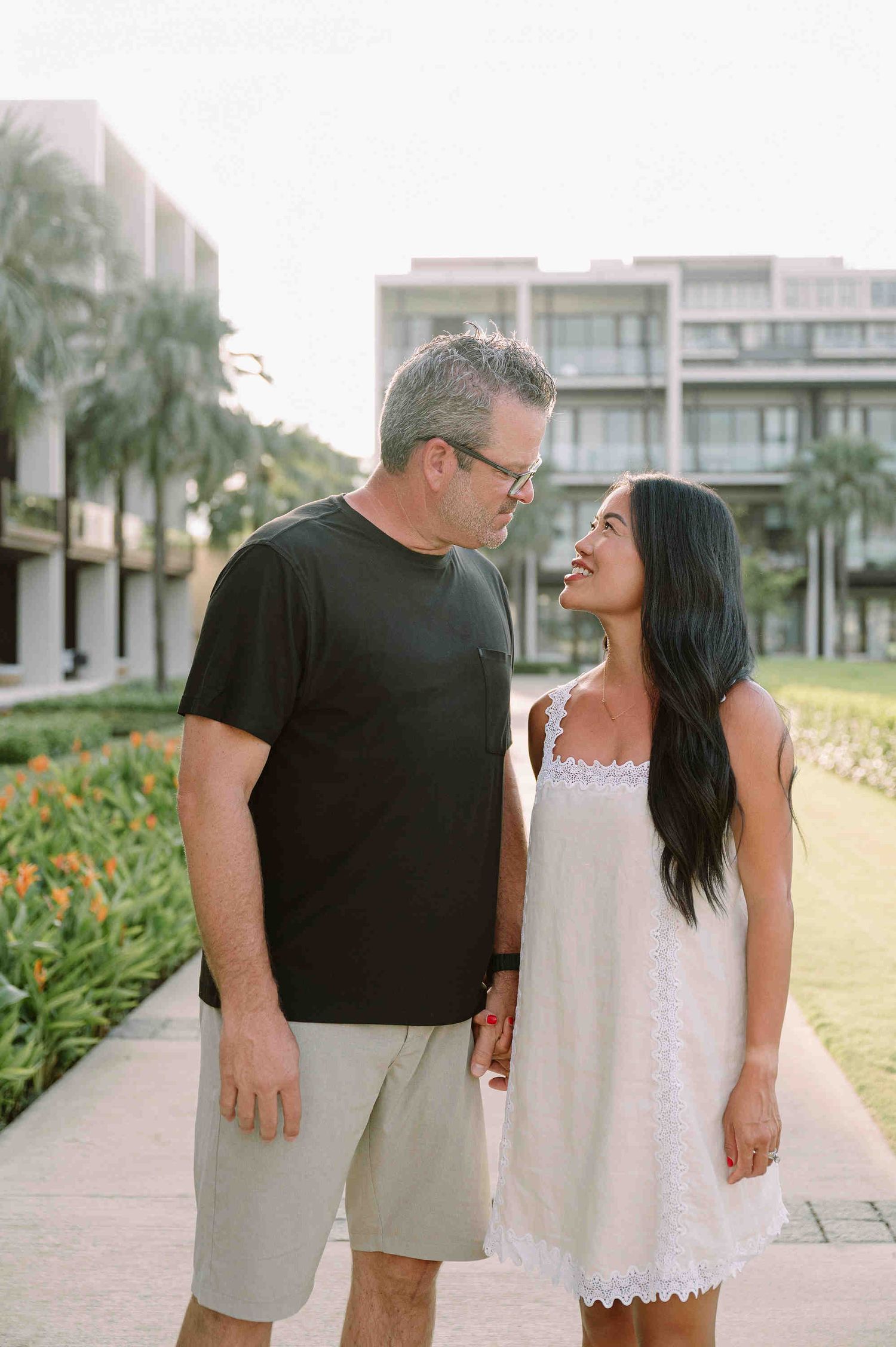Da Nang family: couple shares an intimate moment together on a walkway, by AnhVuWedding.