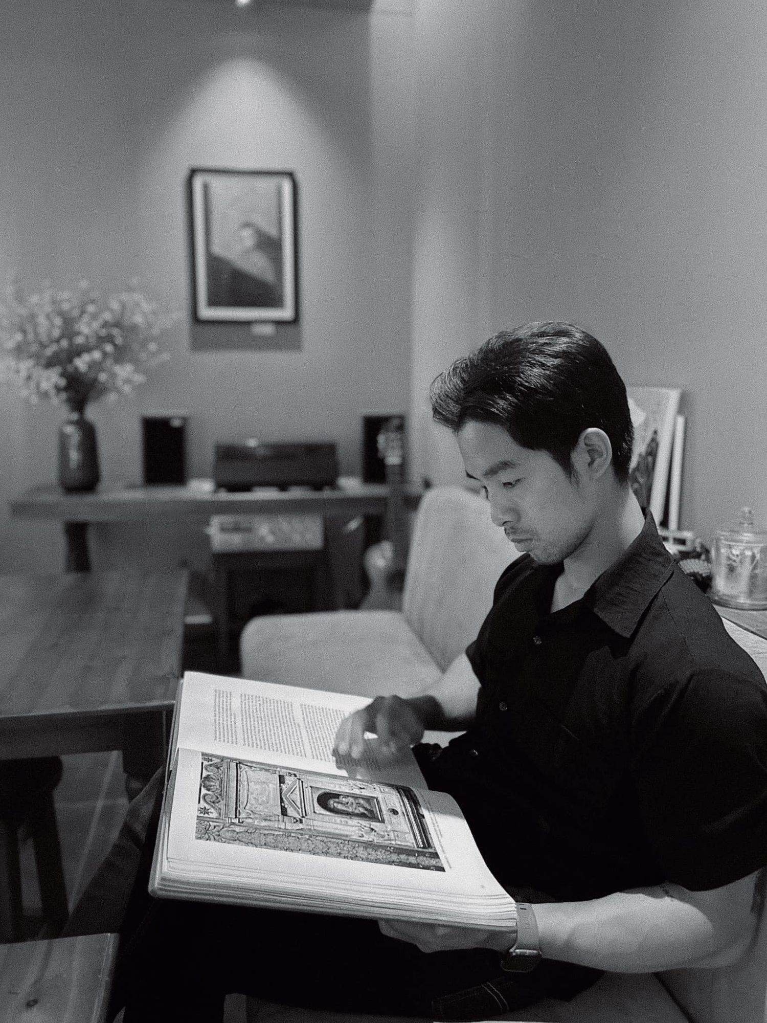 photo: person in a black shirt sits at a desk reading a large book in a sequence of four black and white photographs, by AnhVuWedding.