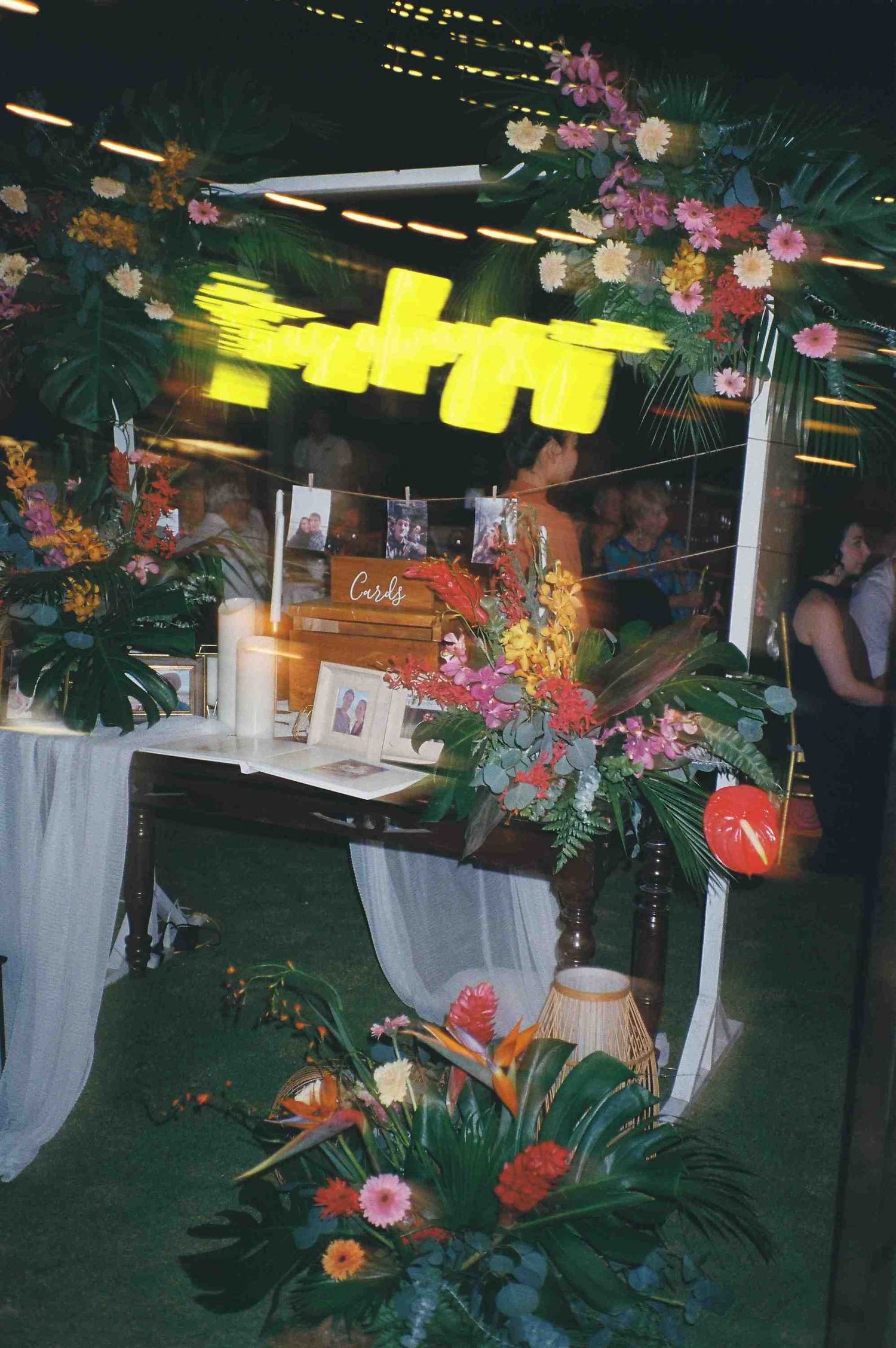 Lang Co wedding: outdoor party venue decorated with hanging lanterns, tropical flowers and white fabric draping, by AnhVuWedding.