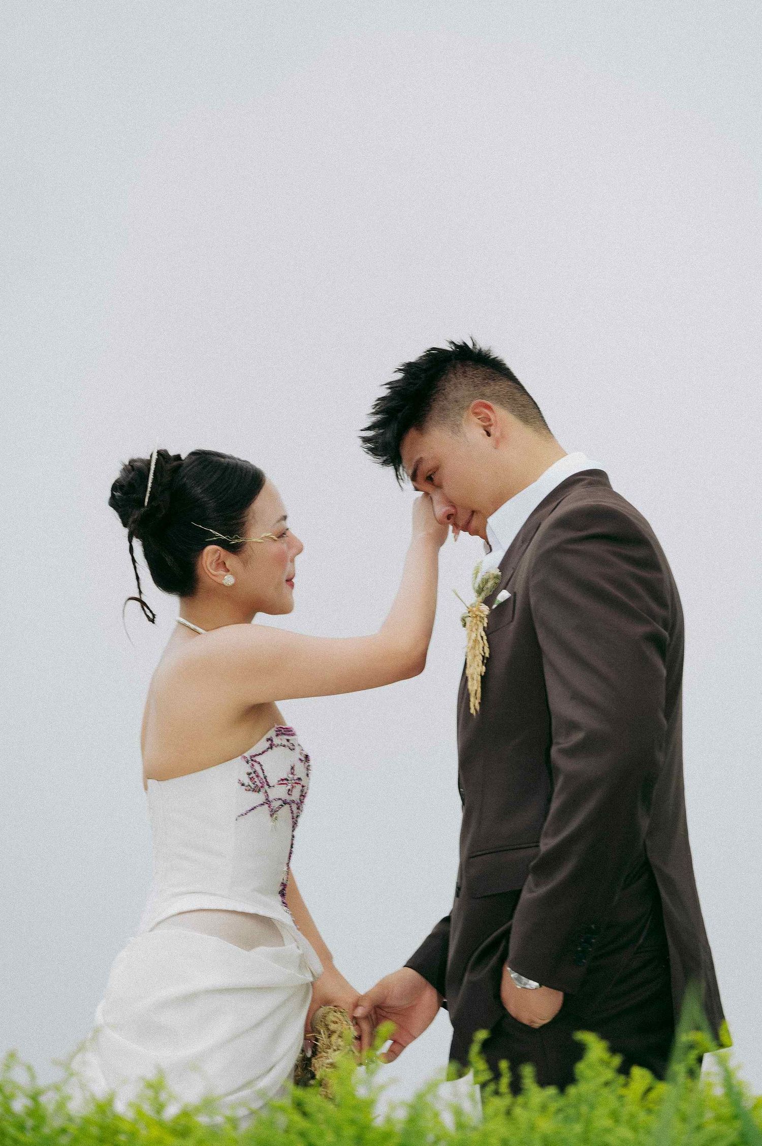 wedding: couple in wedding attire playfully interacting in a series of romantic poses against a light background, by AnhVuWedding.
