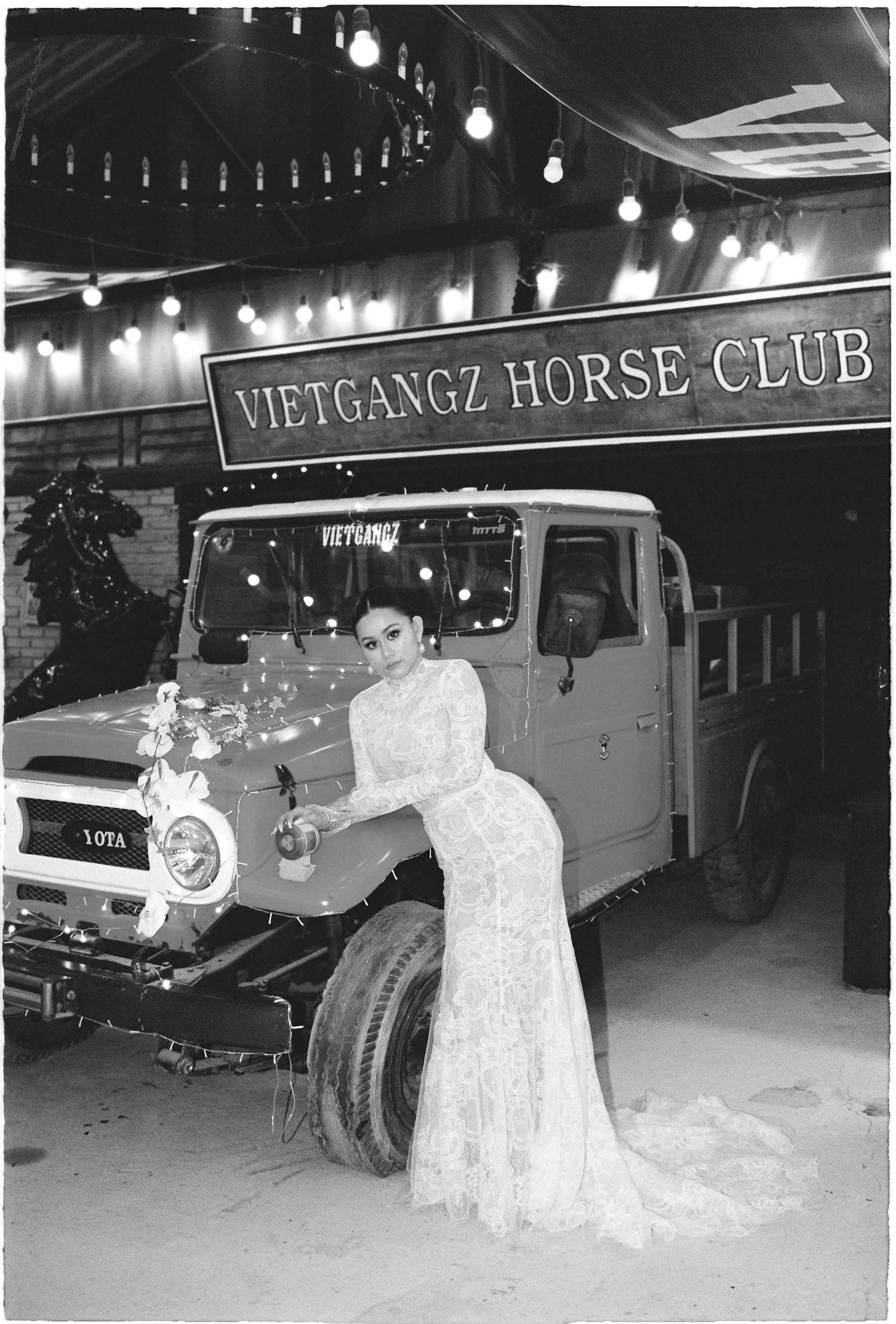 Saigon pre-wedding: wedding photography outside Vietgangz Horse Club with vintage vehicles in black and white, by AnhVuWedding.