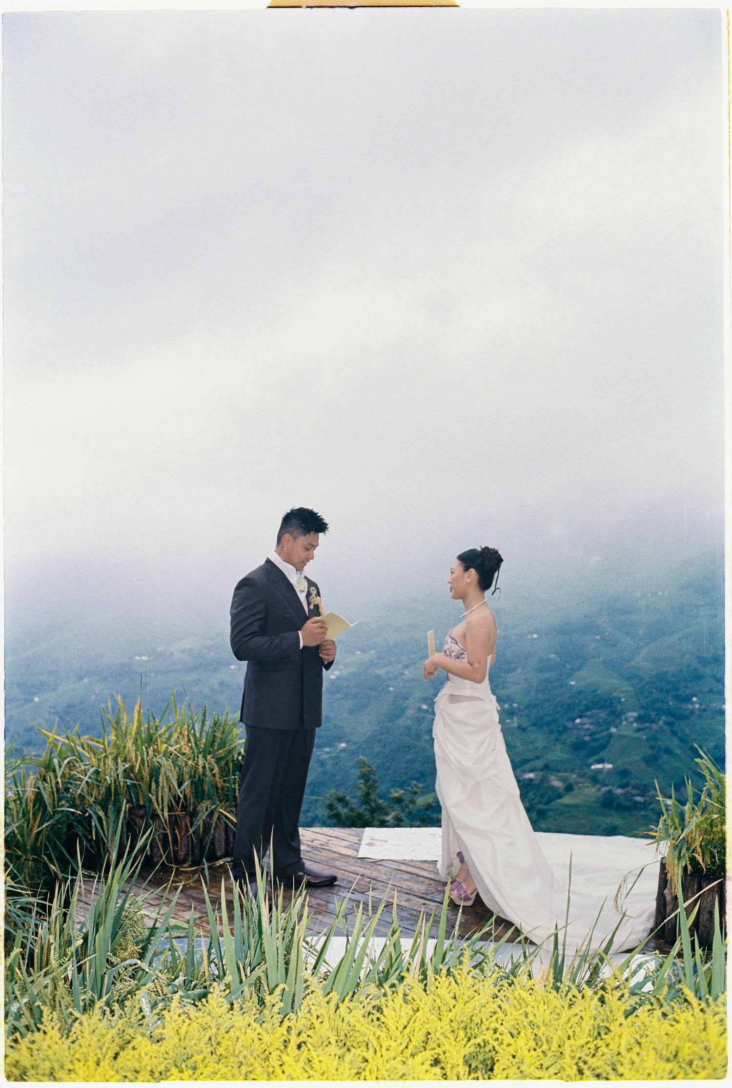 wedding: bride and groom exchanging vows outdoors on a mountain at Sa Pa in Vietnam, intimate wedding photography, by AnhVuWedding.
