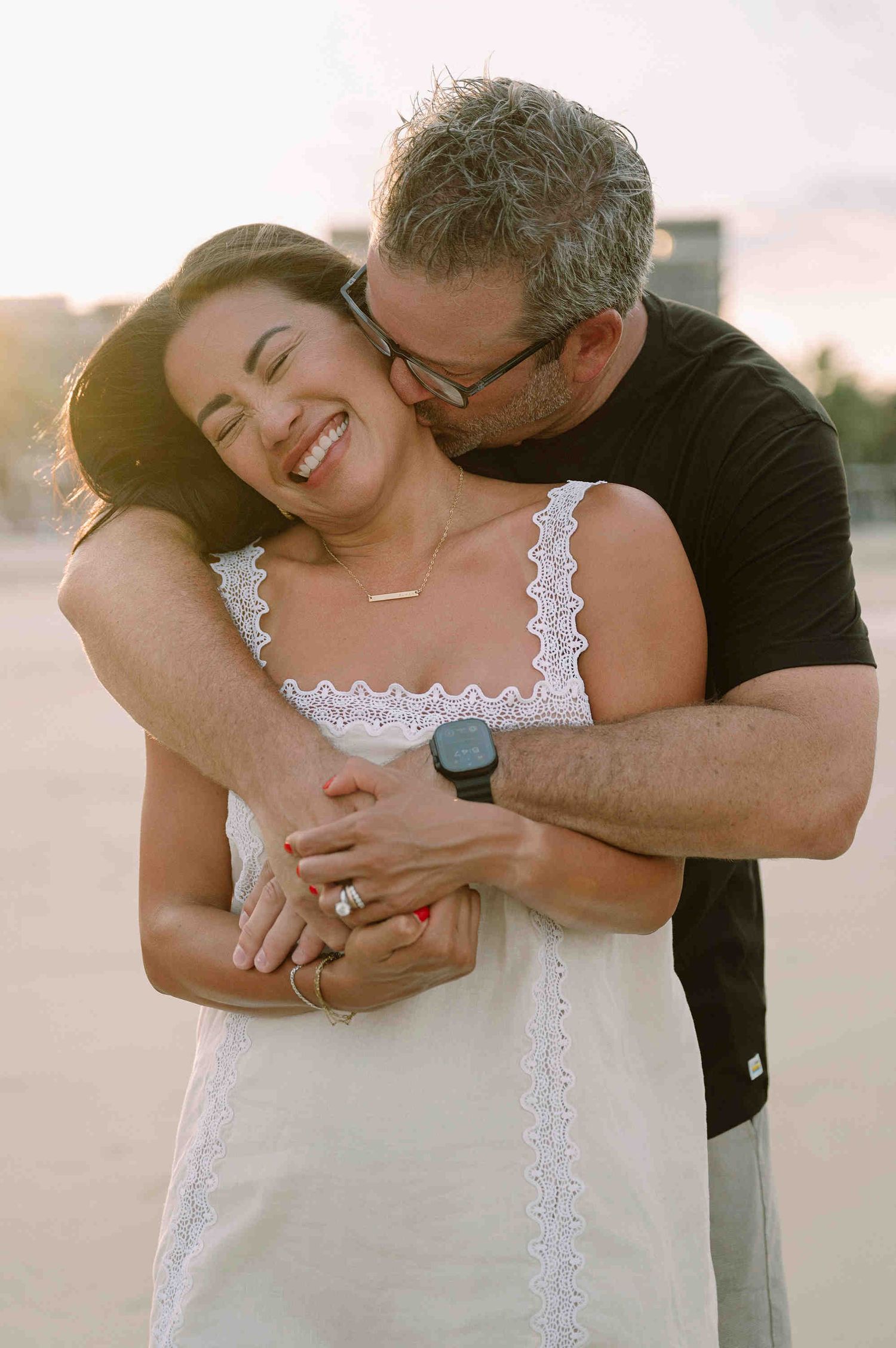 Da Nang family: couple shares a tender embrace and laugh together during sunset, by AnhVuWedding.