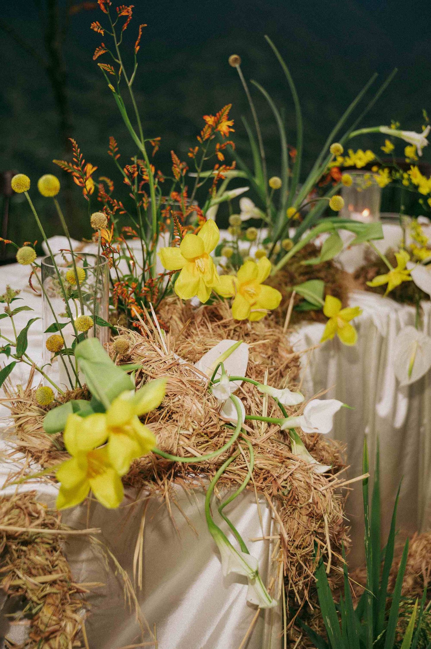wedding: close-up of rustic wedding table decor with yellow daffodils and dried hay arrangements, by AnhVuWedding.