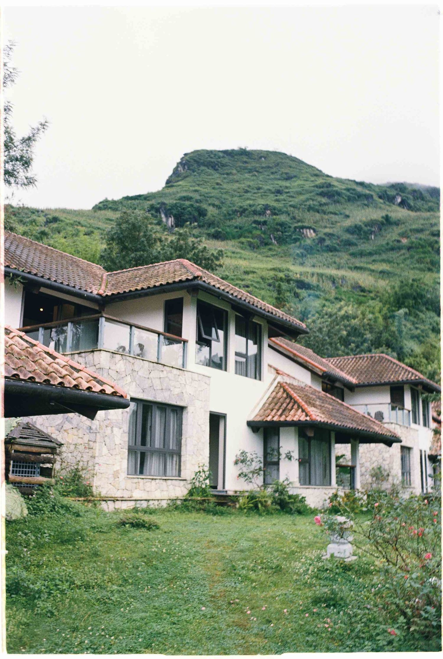 wedding: stone and stucco vacation villas with red tile roofs nestled on a green hillside, by AnhVuWedding.